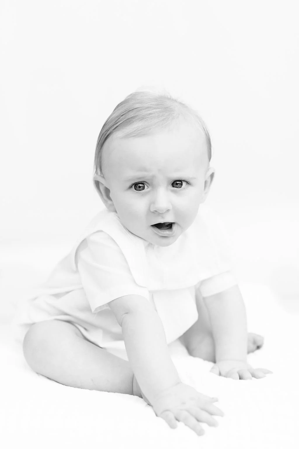 baby sitting and smiling during 6 month photo session Baton Rouge