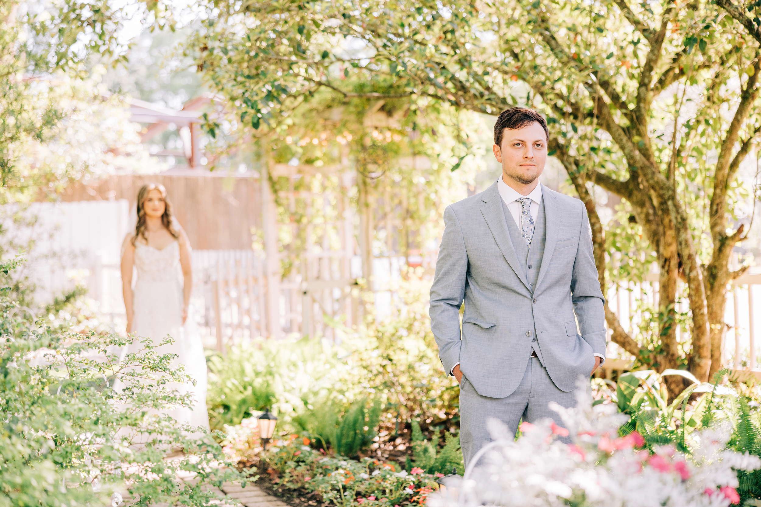 groom waiting for bride to tap his shoulder during first look at baton rouge wedding ceremony