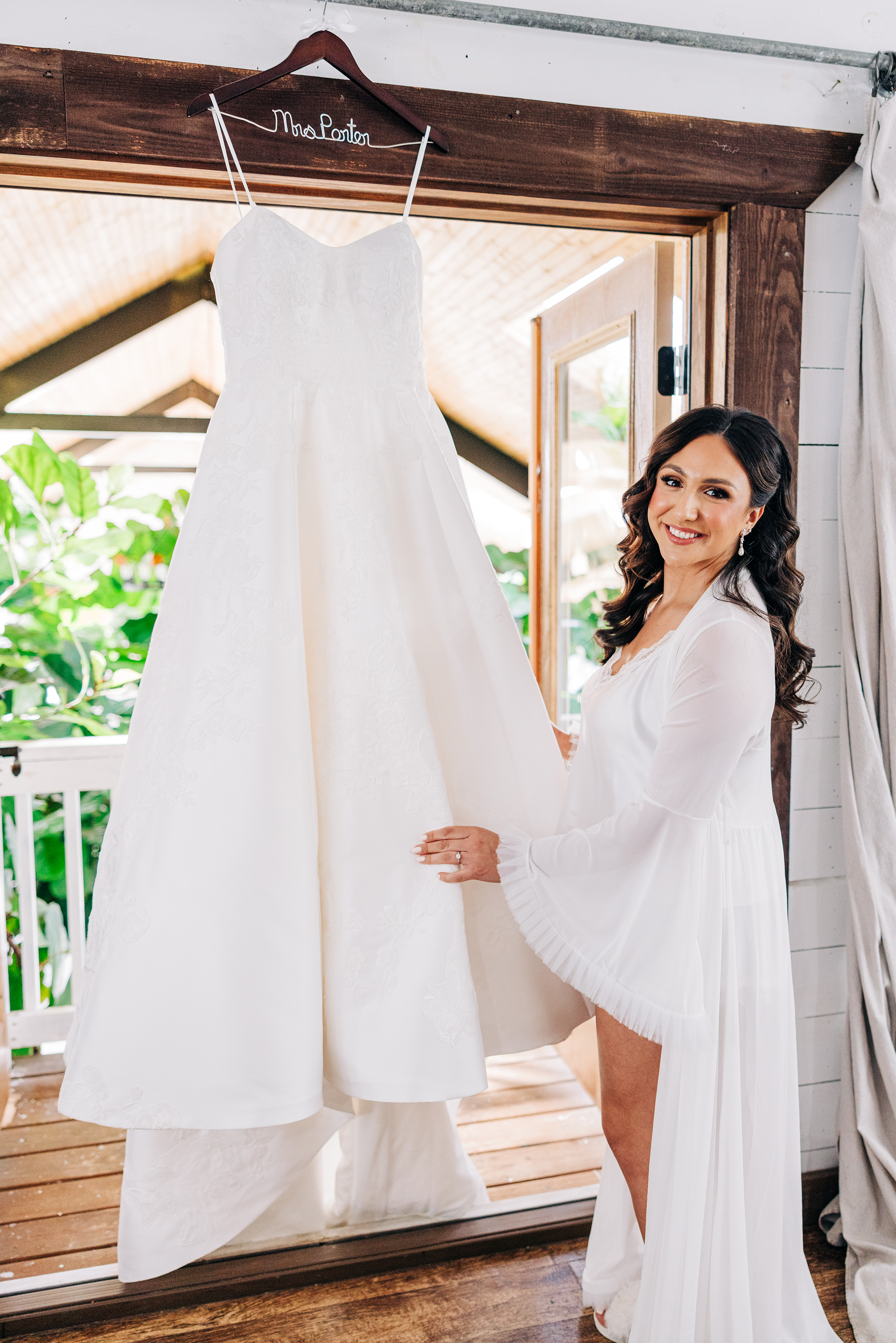 bride standing in front of her dress during getting ready at baton rouge wedding