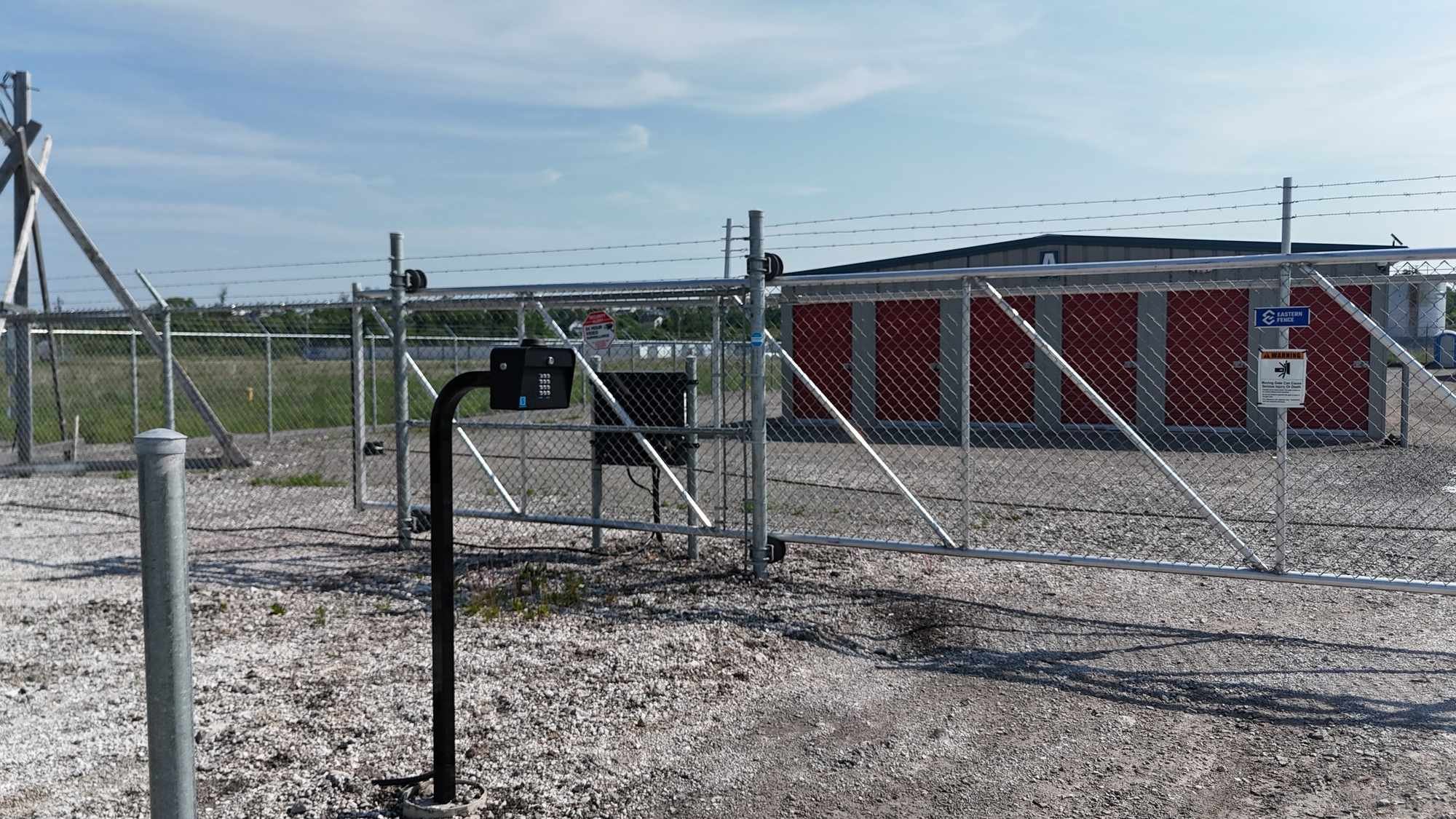 Keypad entry post at the fenced gate of CoastGuard Self Storage