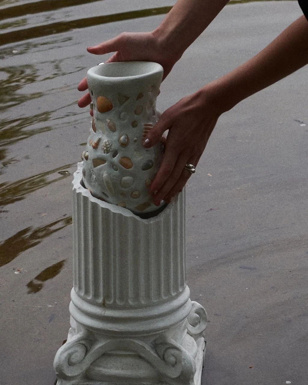 mosaic vase being placed in greek column
