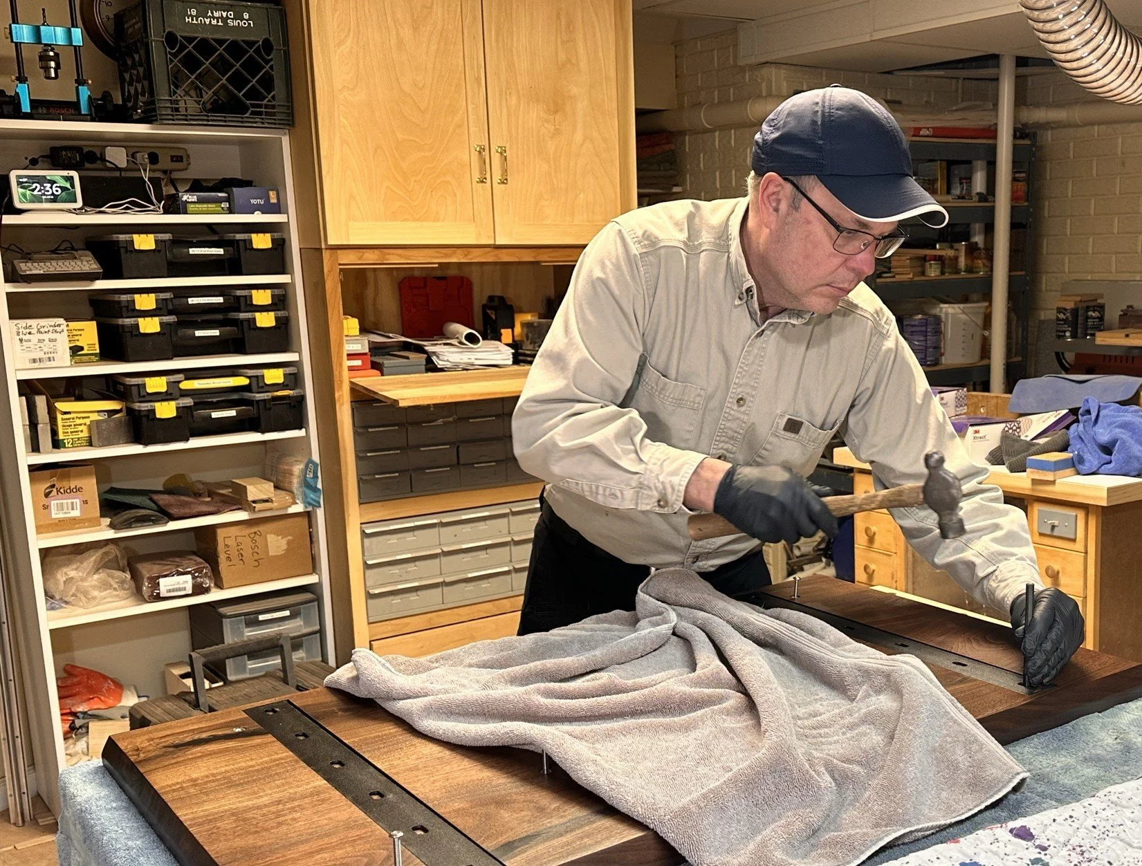 Bryan inlaying steel stiffeners into back of a slab table top.