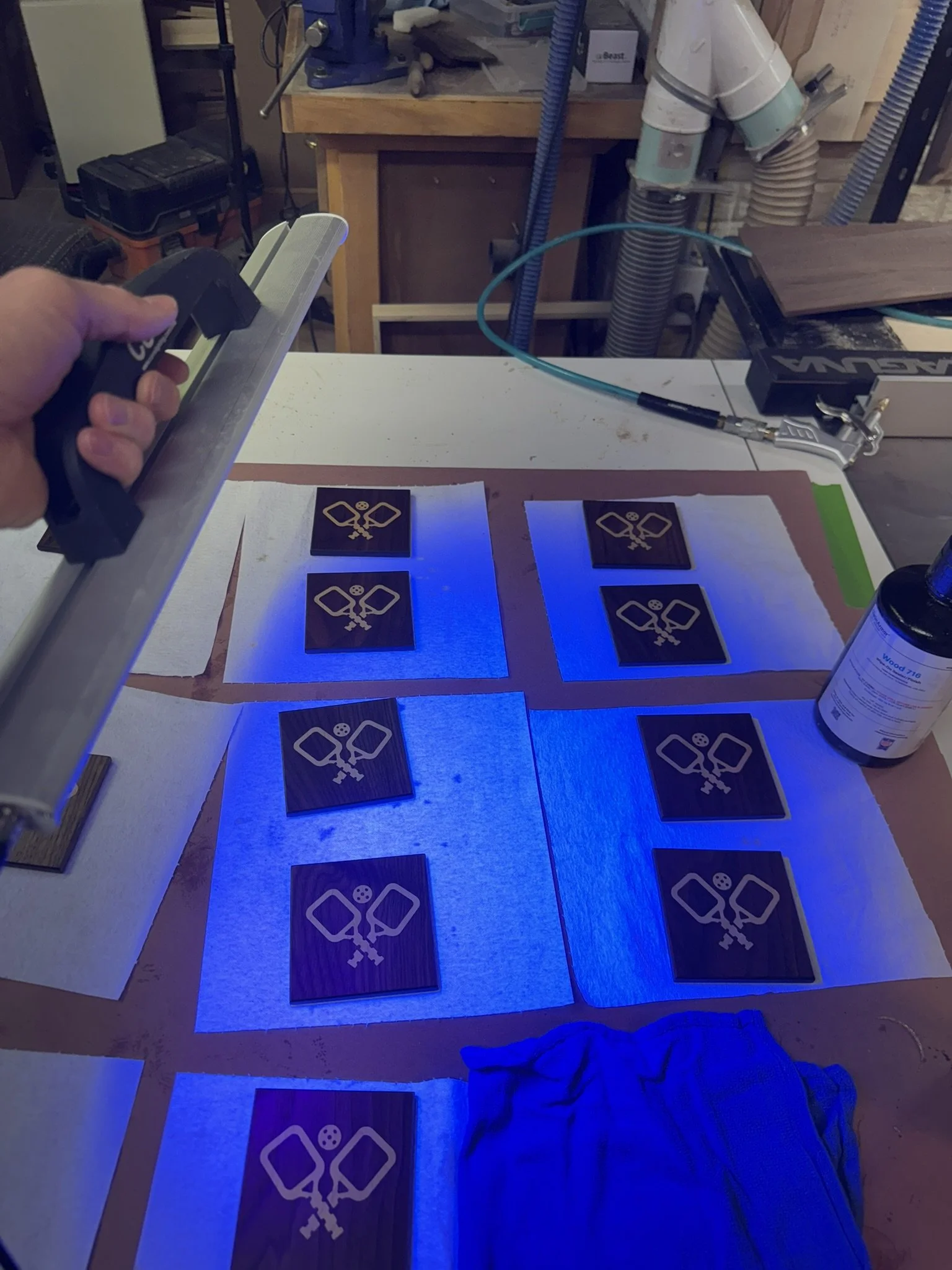 Applying cross-linked polymer, UV cured finish to pickleball paddle and ball coasters