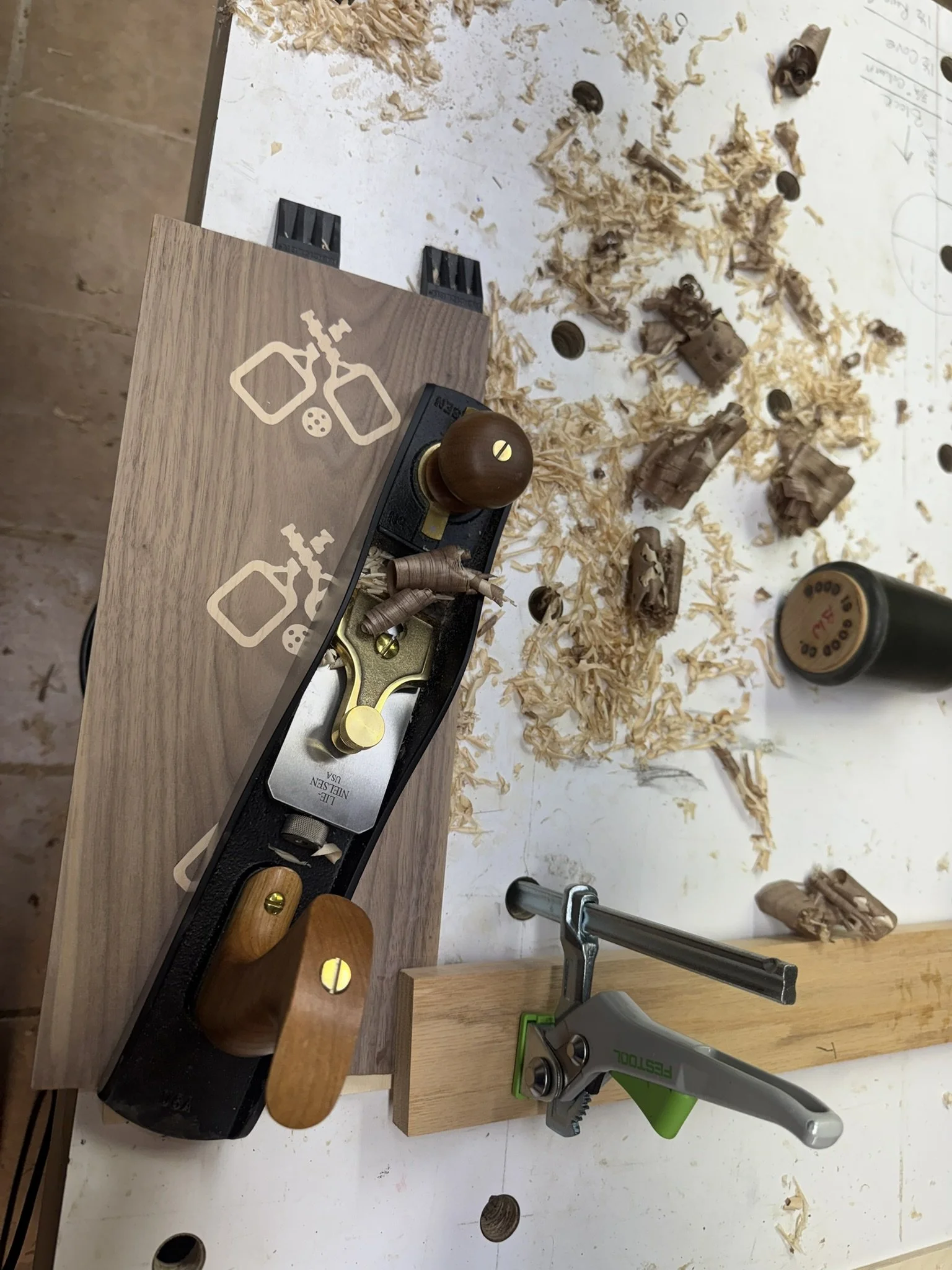 Planning the inlays smooth with the surface of the walnut with a low angle jack plane