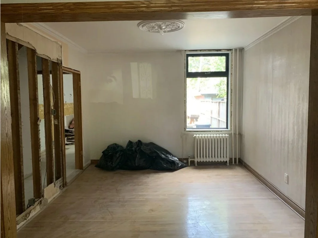 Living room with walls opened up during demo, Grace Street Victorian renovation Toronto