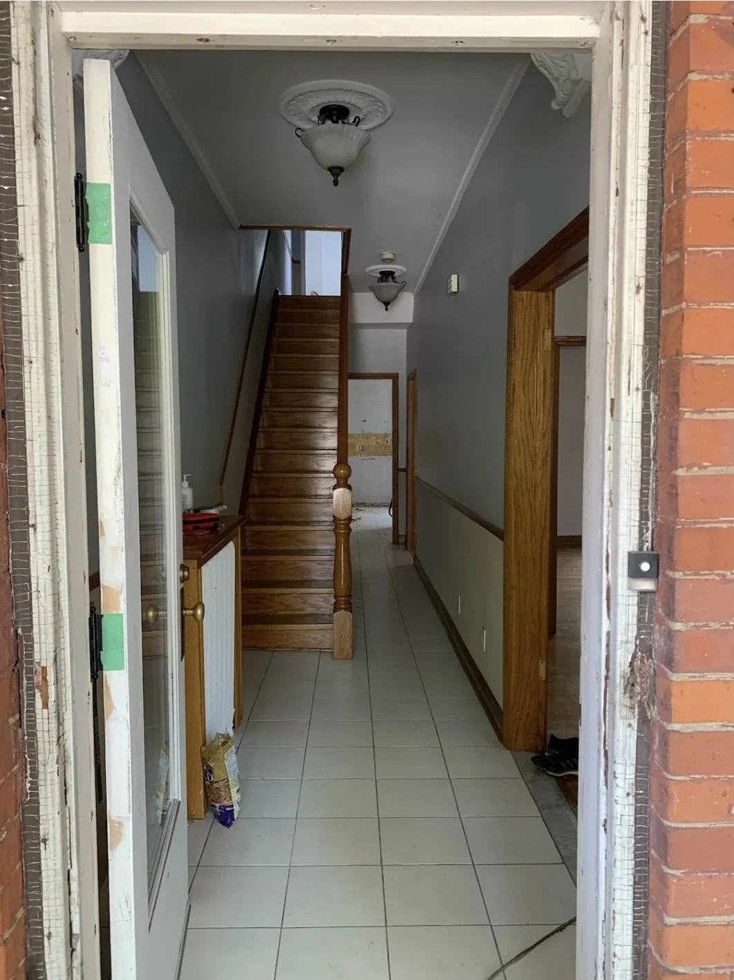 Original foyer and hallway before renovation, Grace Street Victorian home Toronto