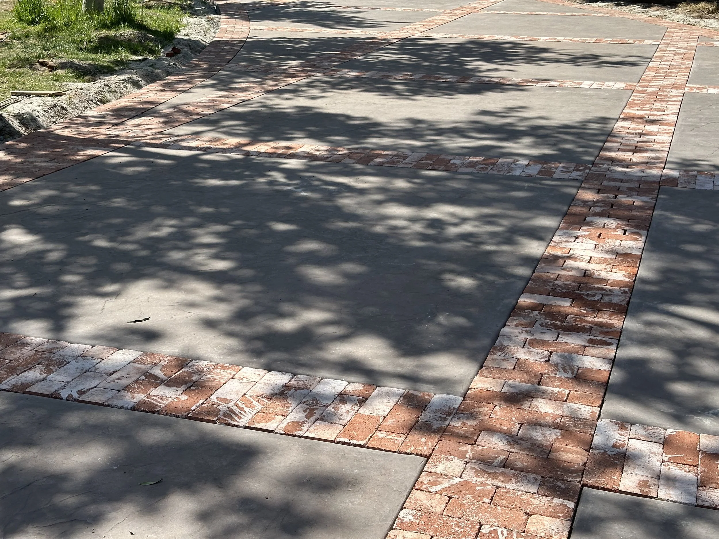 Custom Driveway (Stamped Base with Red Brick Accents)