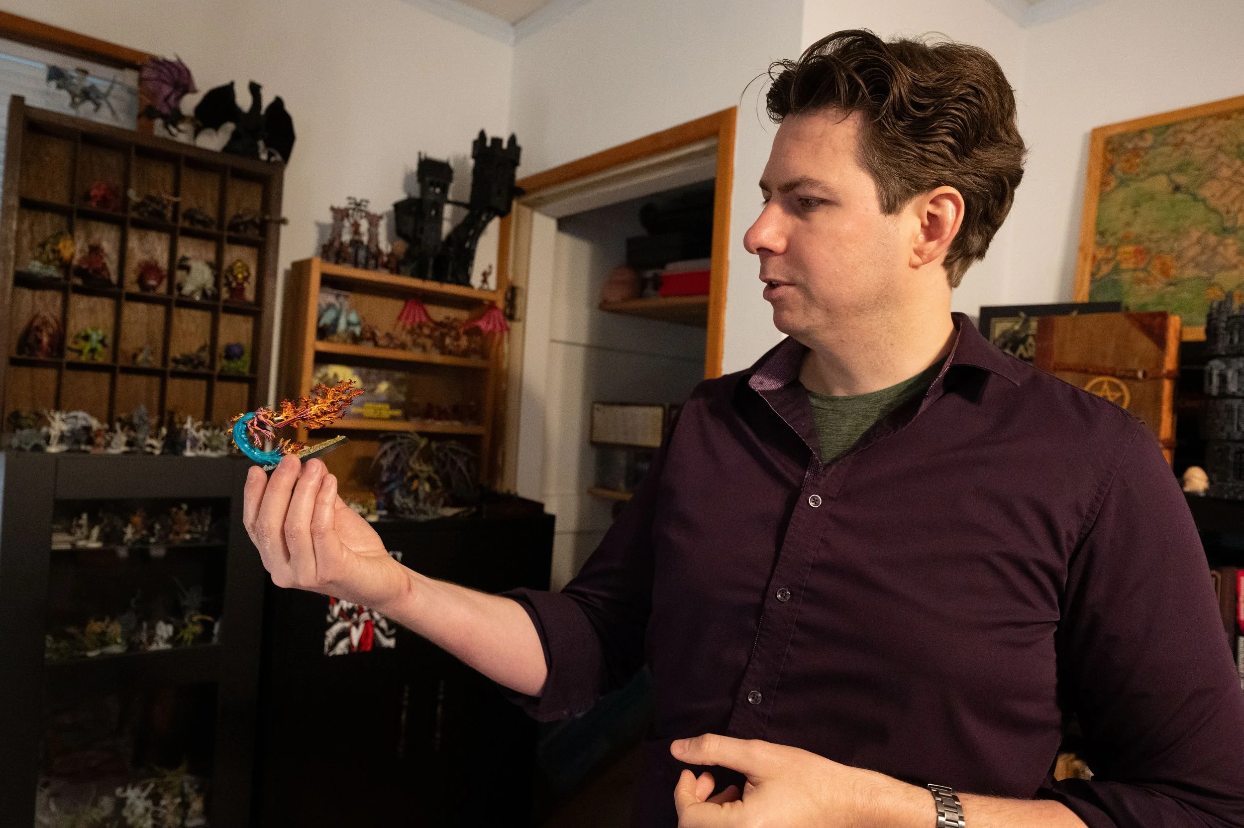 Allan Knowles, founder of Dungeons and Dragons service company Danger Wizard and co-organizer of SomerCon shows off a favorite minature he's painted from his collection of hundreds in his home in Somerville, MA, on April 8, 2025.