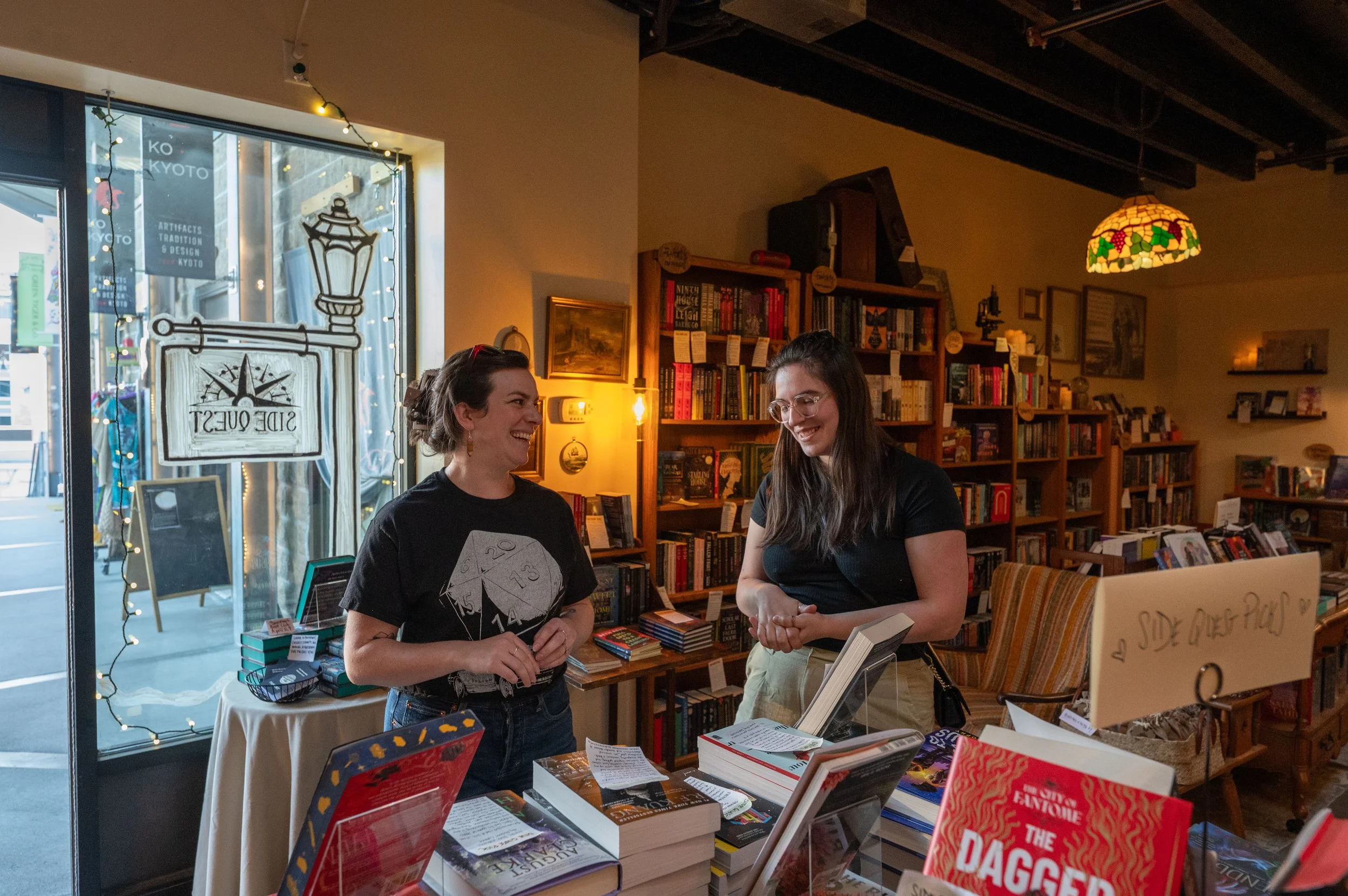 Caroline Sheridan, founder of SideQuest Books and Games, works with a new customer, asking questions to best understand their taste and make a book recommendation in her store in Somerville, MA, on Friday, April 4, 2025.