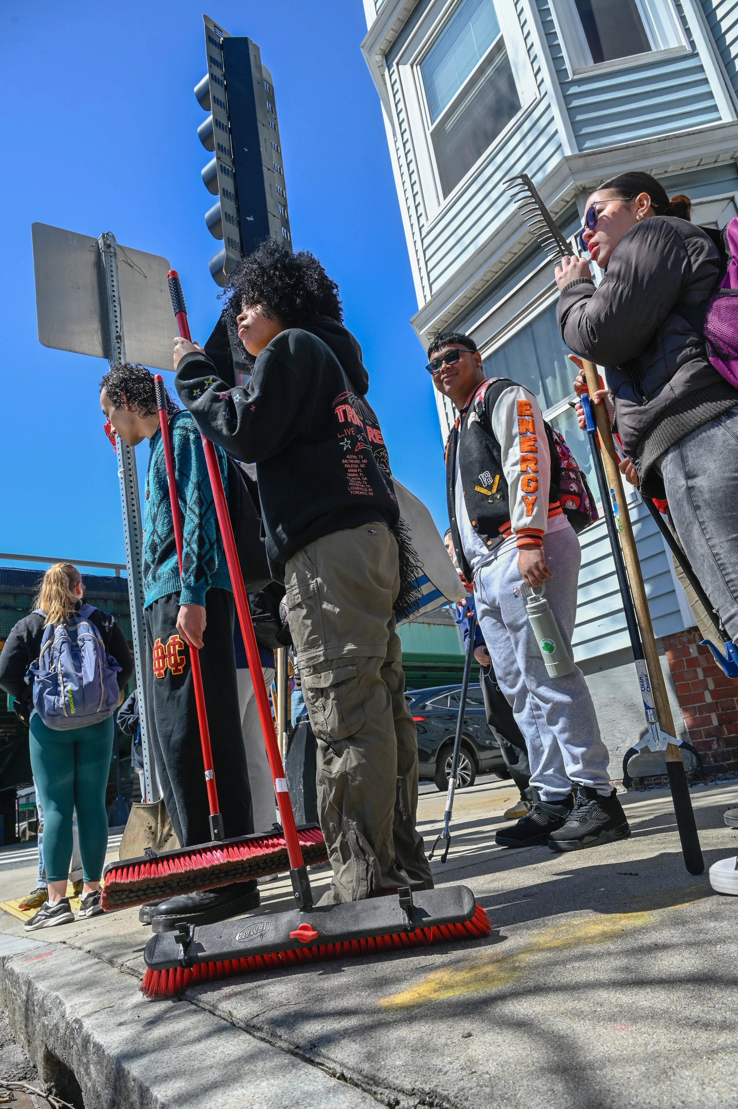 East Boston, MA: April 22, 2024 - Members of the Climate Corps trek to the Mary Ellen Welch Greenway, equipment in hand. There, they plan to spend hours building new features around the path to reduce flooding and soil erosion, making it more communi