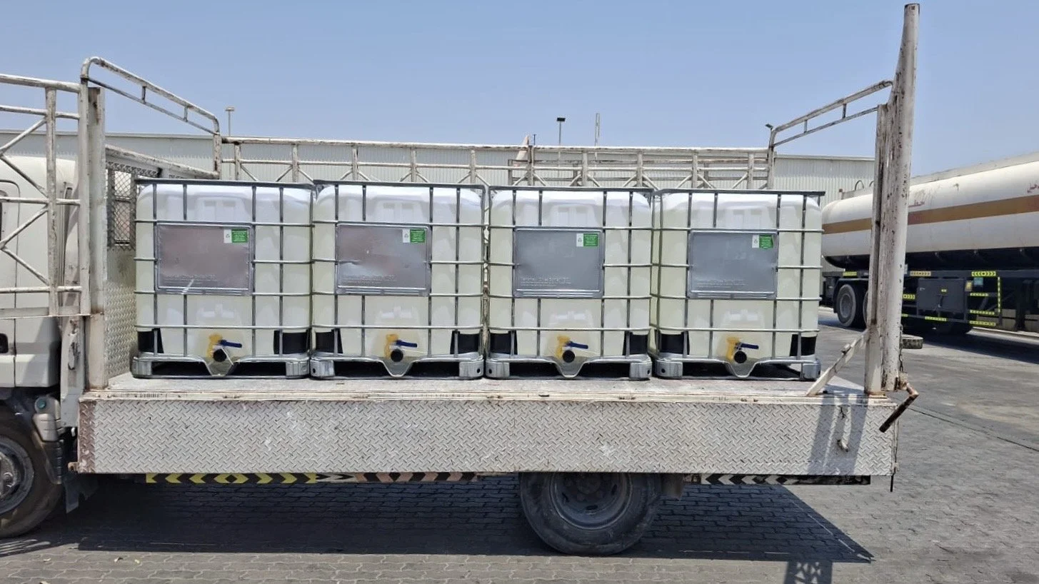 3-ton flatbed truck transporting four IBC chemical tanks in Dubai using Trucky logistics