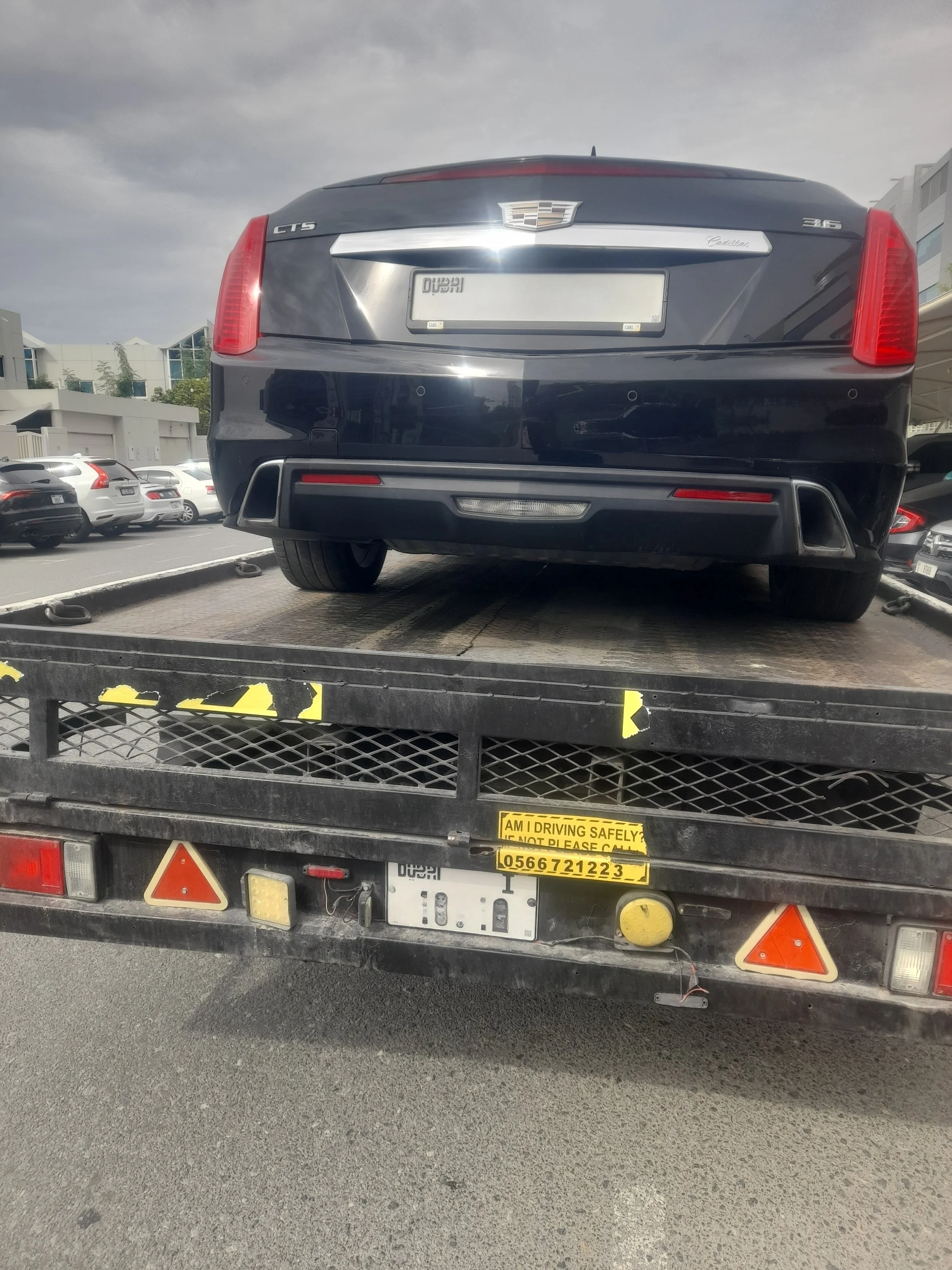 Standard recovery truck loading a sedan in Dubai