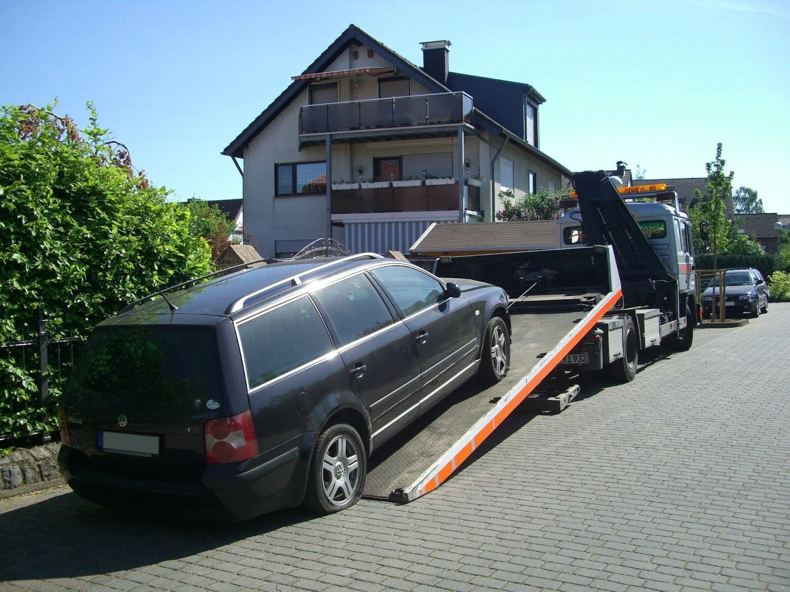 Tow truck unloading a broken car