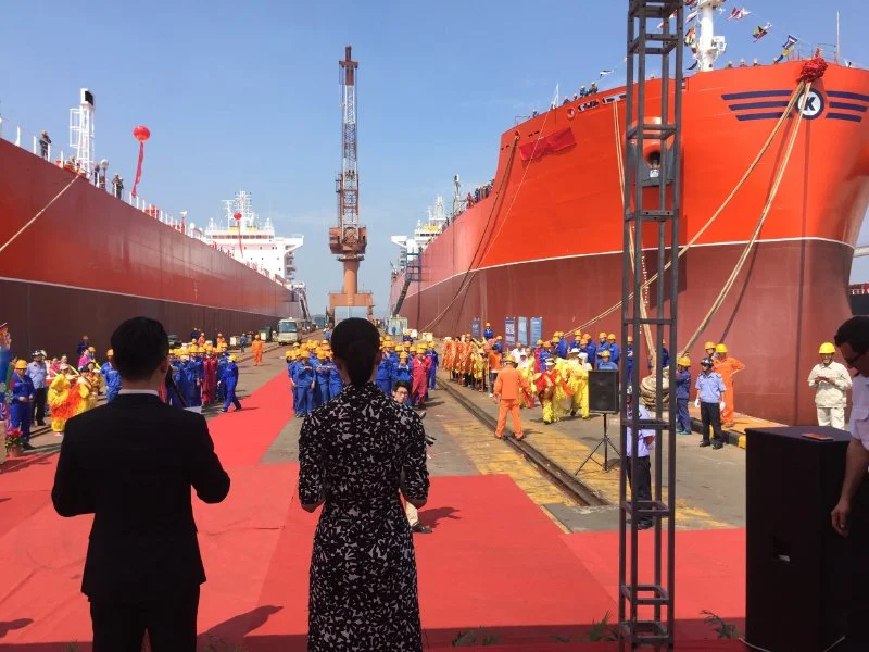 People walking towards two new ships