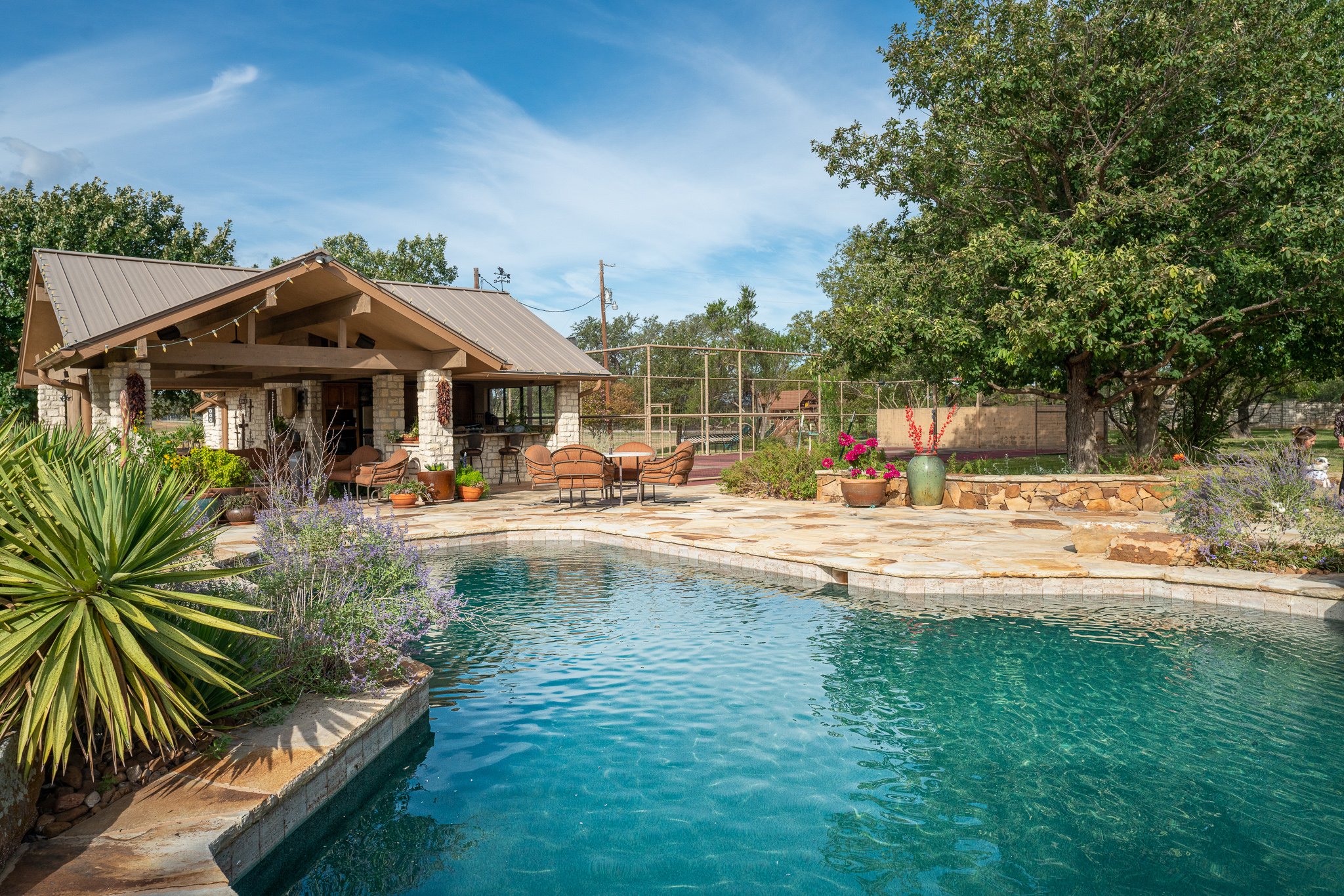 Pool, patio and tennis court on a Texas ranch