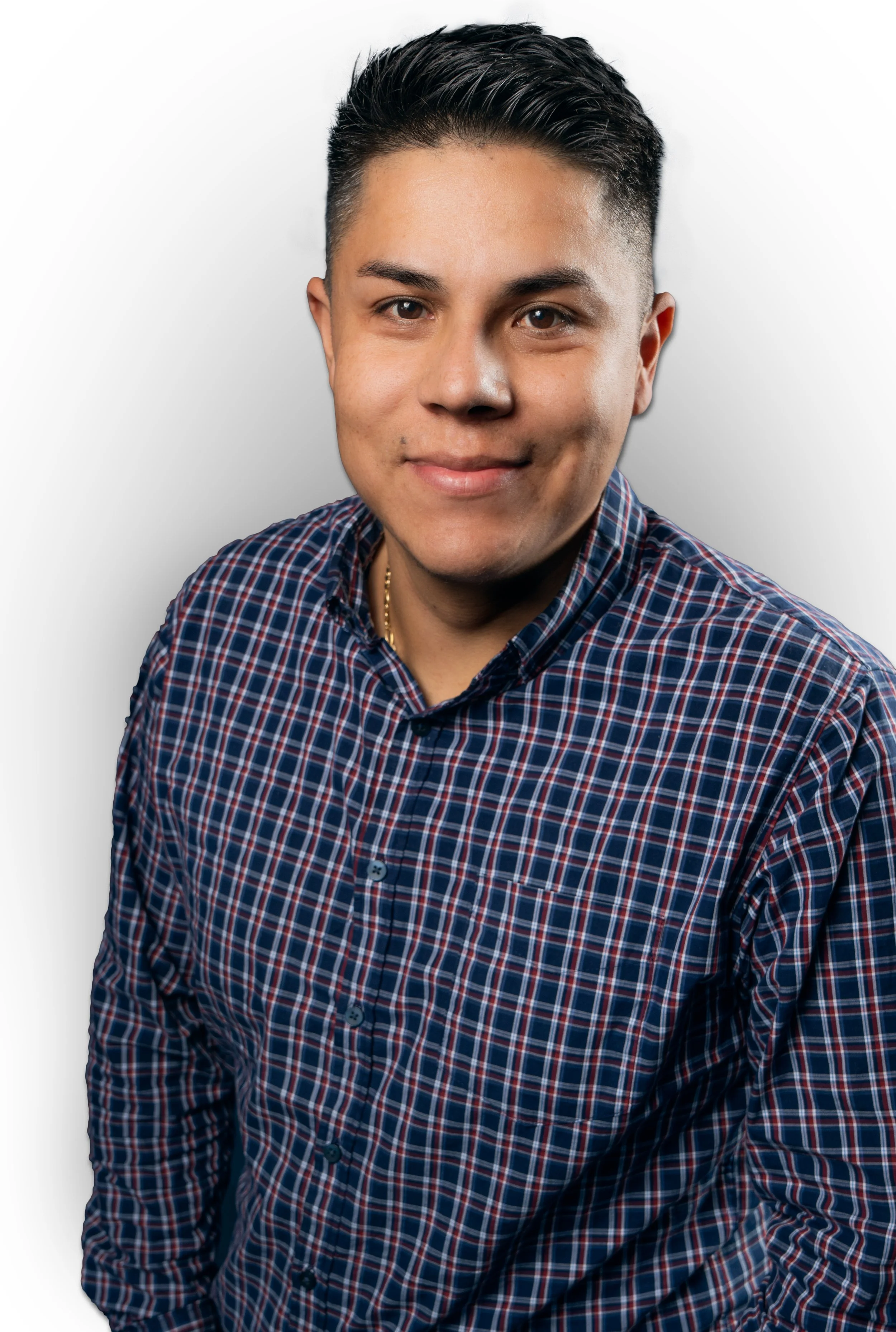 Black and white portrait of a young man with short, styled hair, wearing a checkered collared shirt, looking at the camera with a neutral expression.