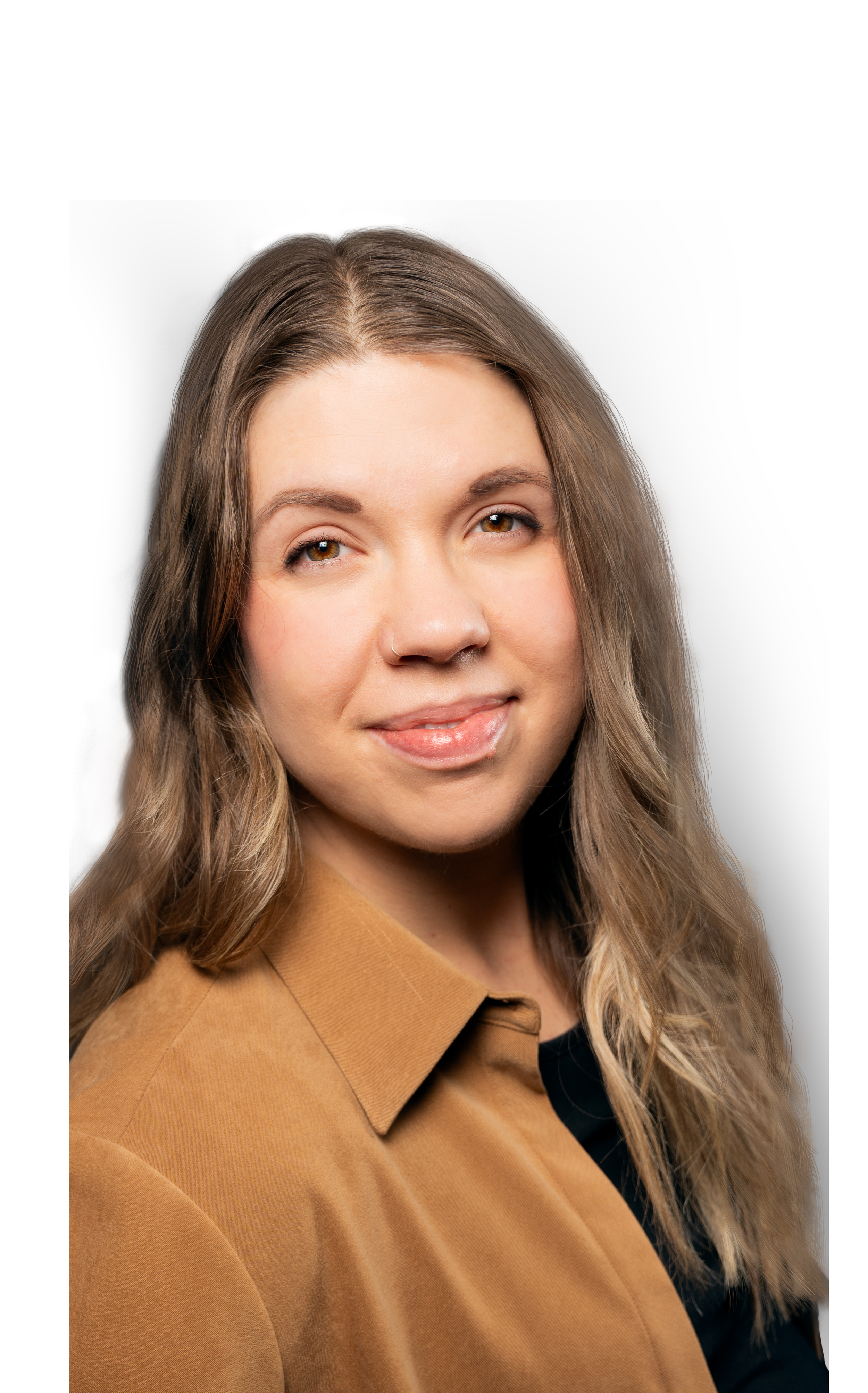 A young woman with long blonde hair smiling and crossing her arms, wearing a black shirt against a white background.