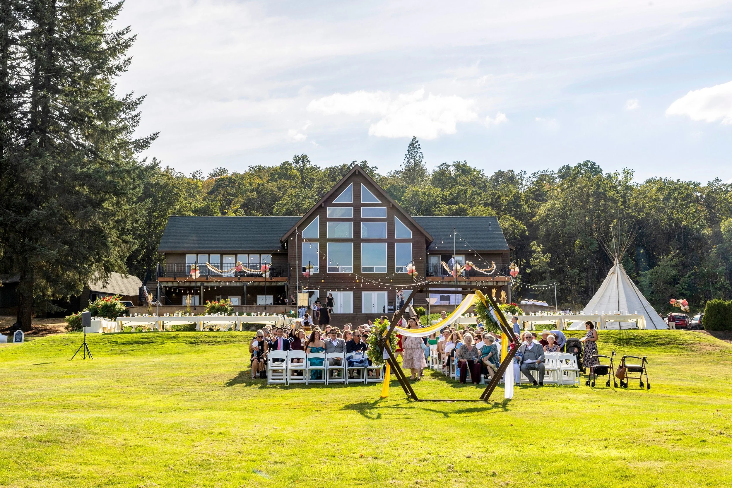 A native american teepee provides a unique backdrop at this outdoor wedding near Eugene Oregon