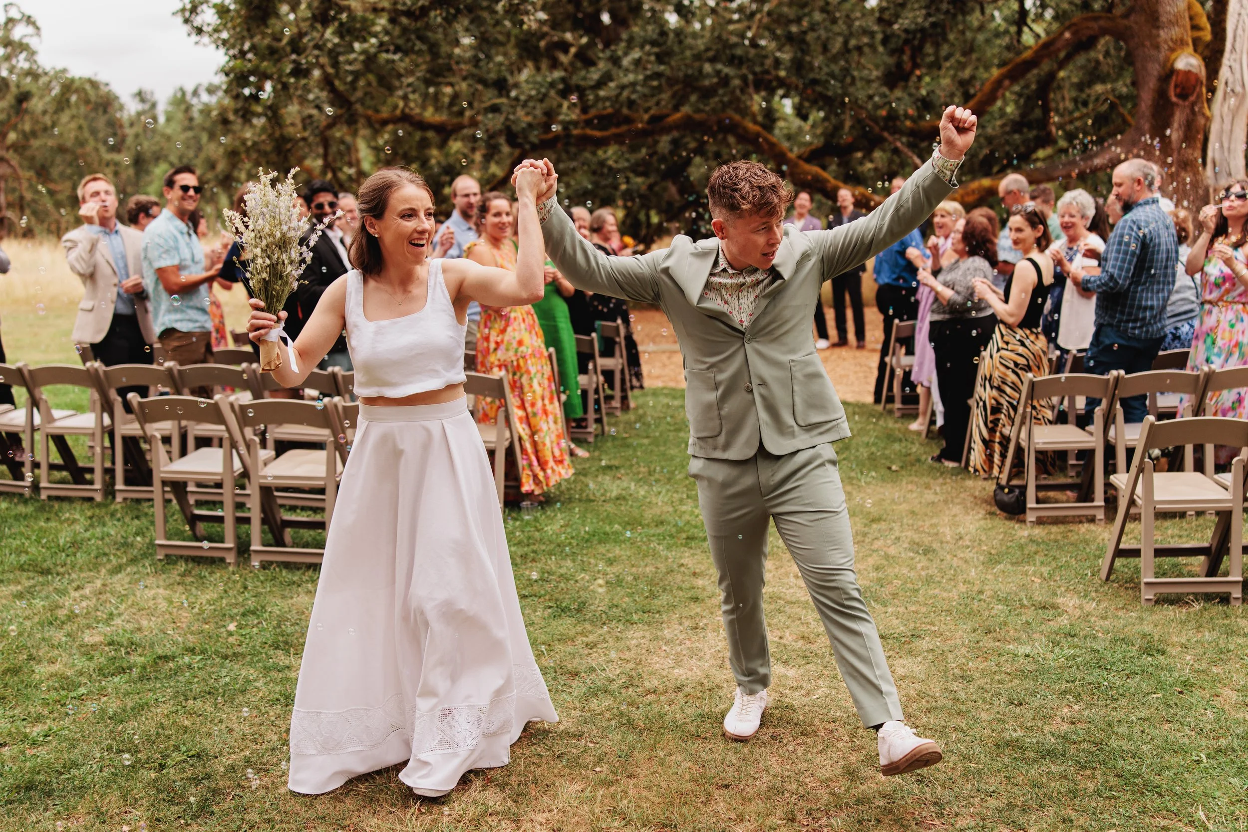 A wedding couple celebrates getting married in a nontraditional ceremony at Mount Pisgah Arboretum in Eugene, Oregon