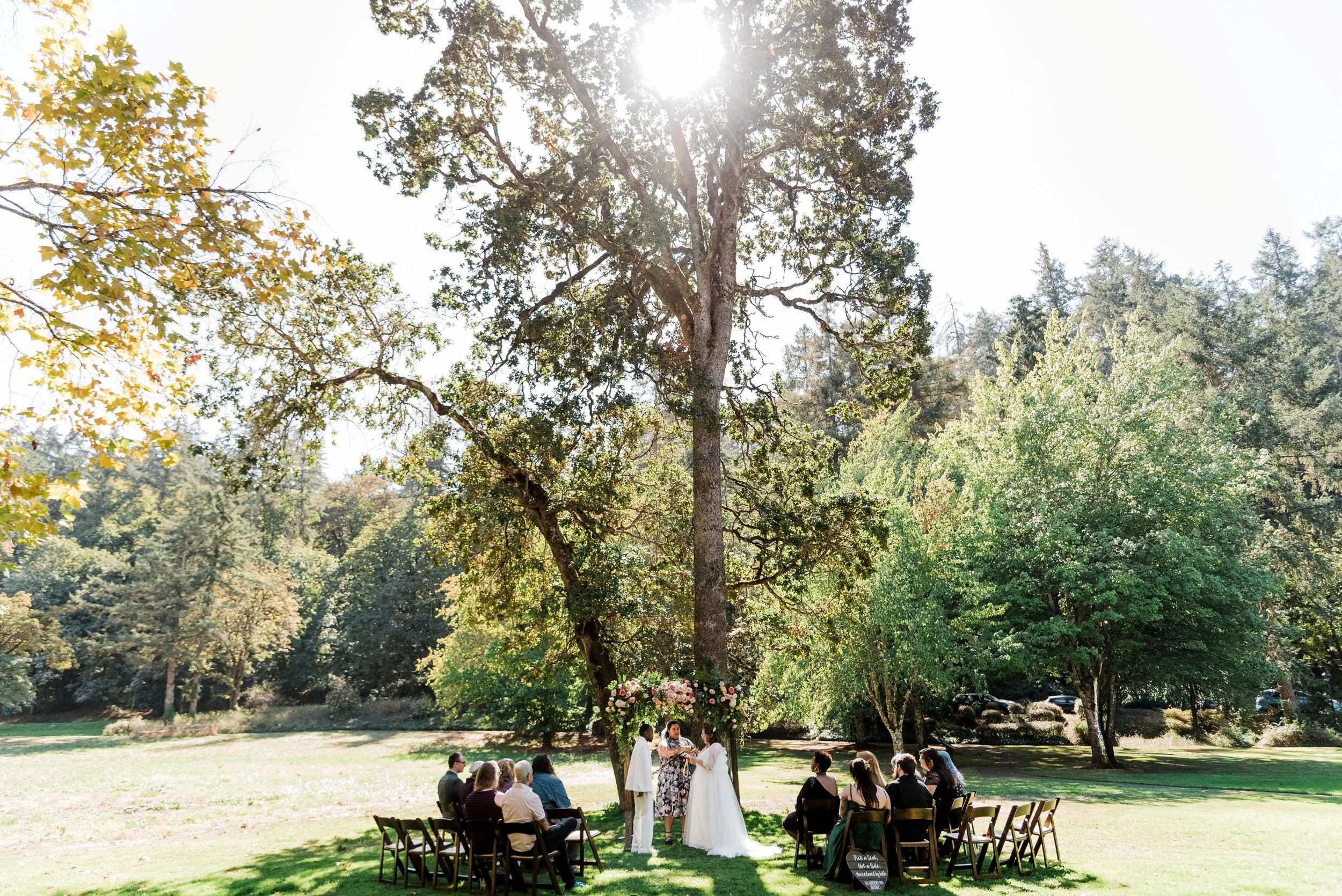 A couple is married on the Eugene Riverfront next to Lamb Cottage in Oregon