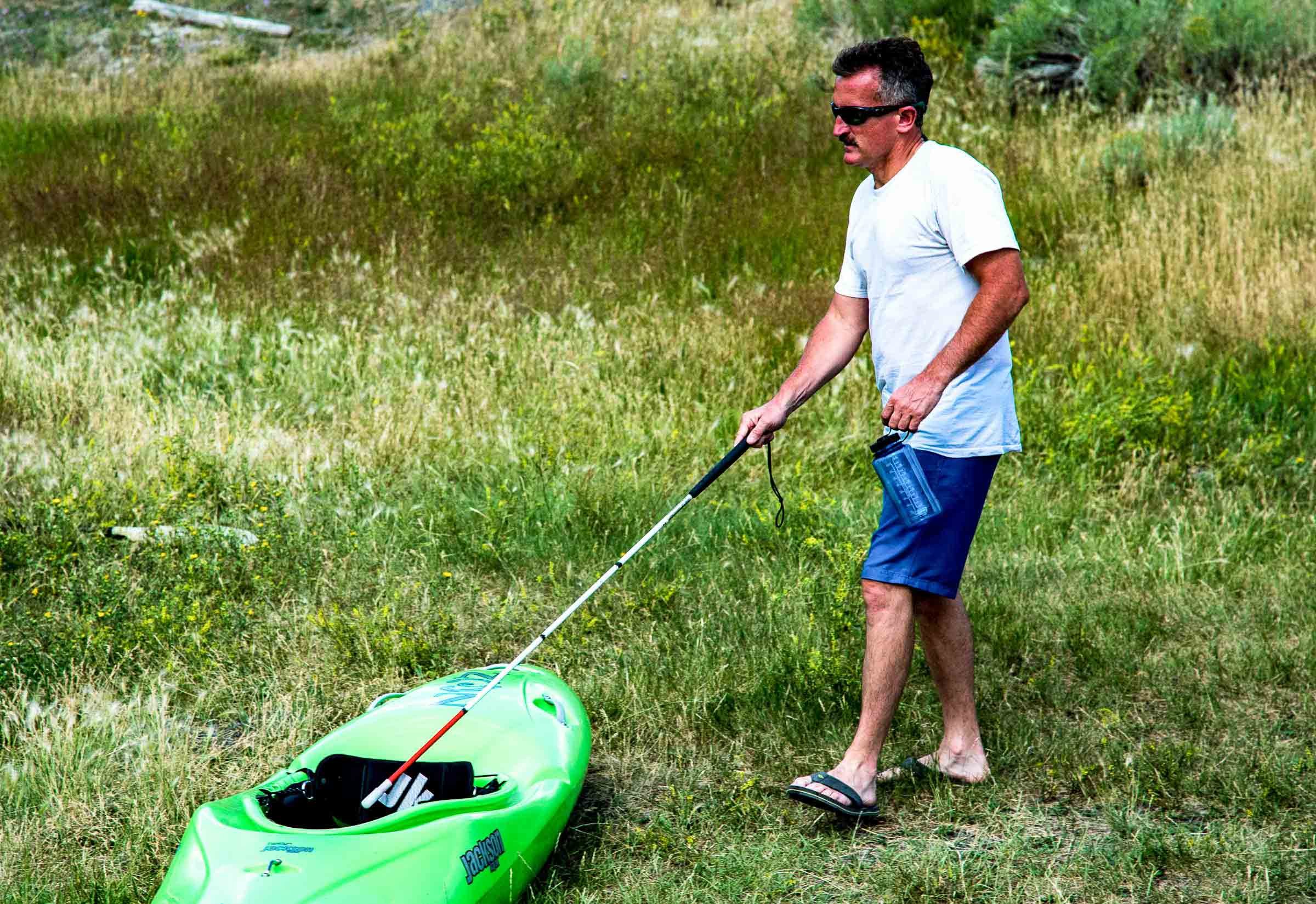 blind kayaker lonnie bedwell finds his boat with his cane montana.jpg