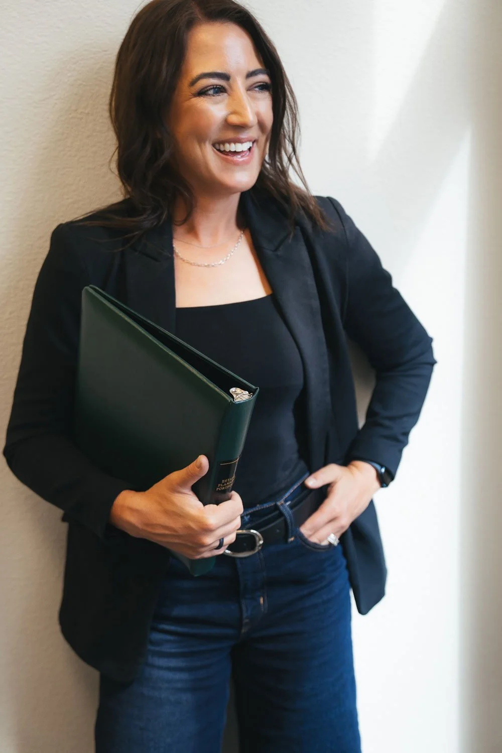 Kara Noble, an Estate planning lawyer in Peoria and Flagstaff, AZ holding a binder