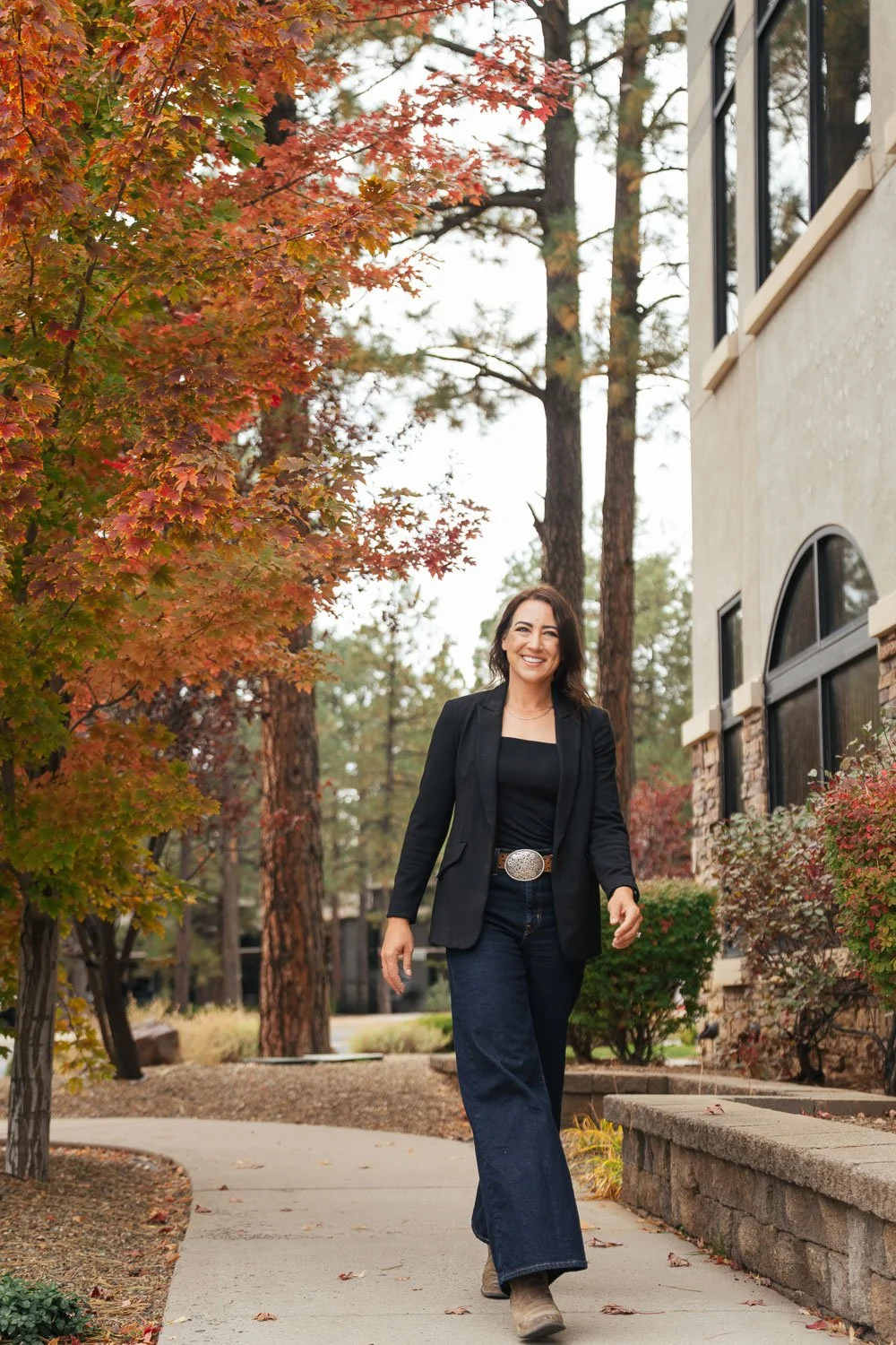 woman walking along a sidewalk outside