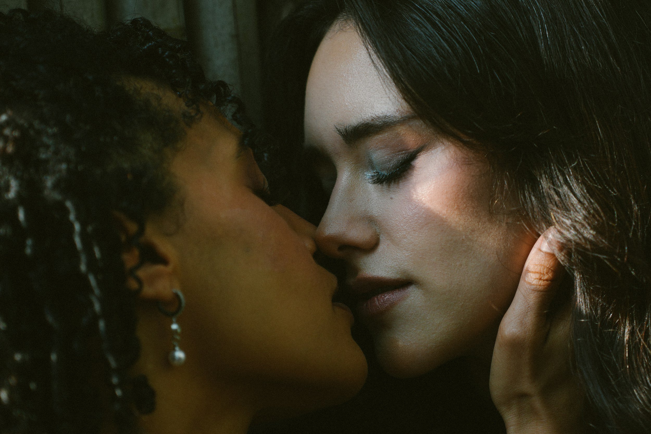 Two women in intimate close portrait — affirming therapy for queer women, same-sex couples, and LGBTQIA+ adults in California
