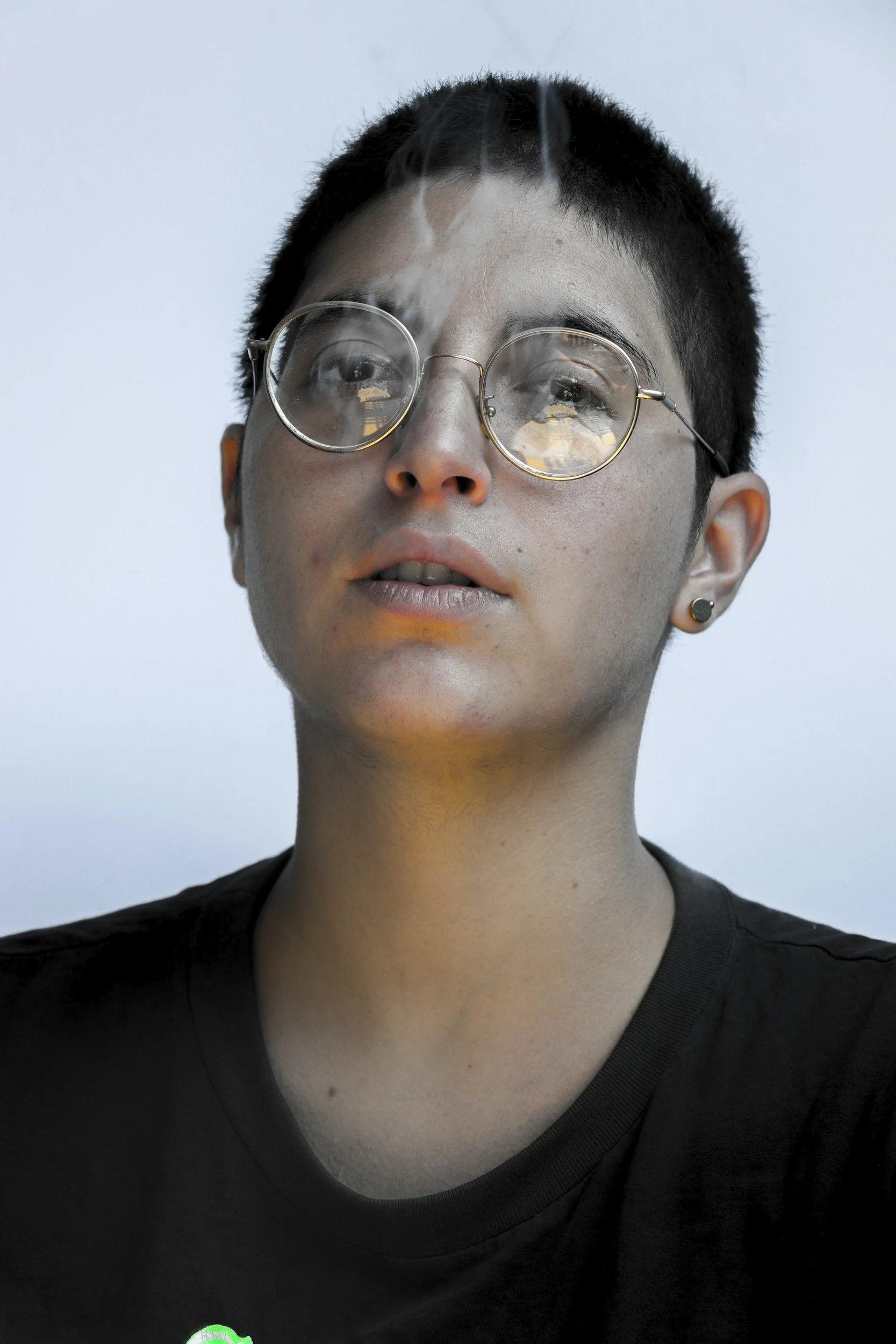 Queer nonbinary adult in contemplative portrait — affirming somatic therapy for LGBTQIA+, gender-diverse, and neurodivergent adult needing an ENM friendly therapist in California