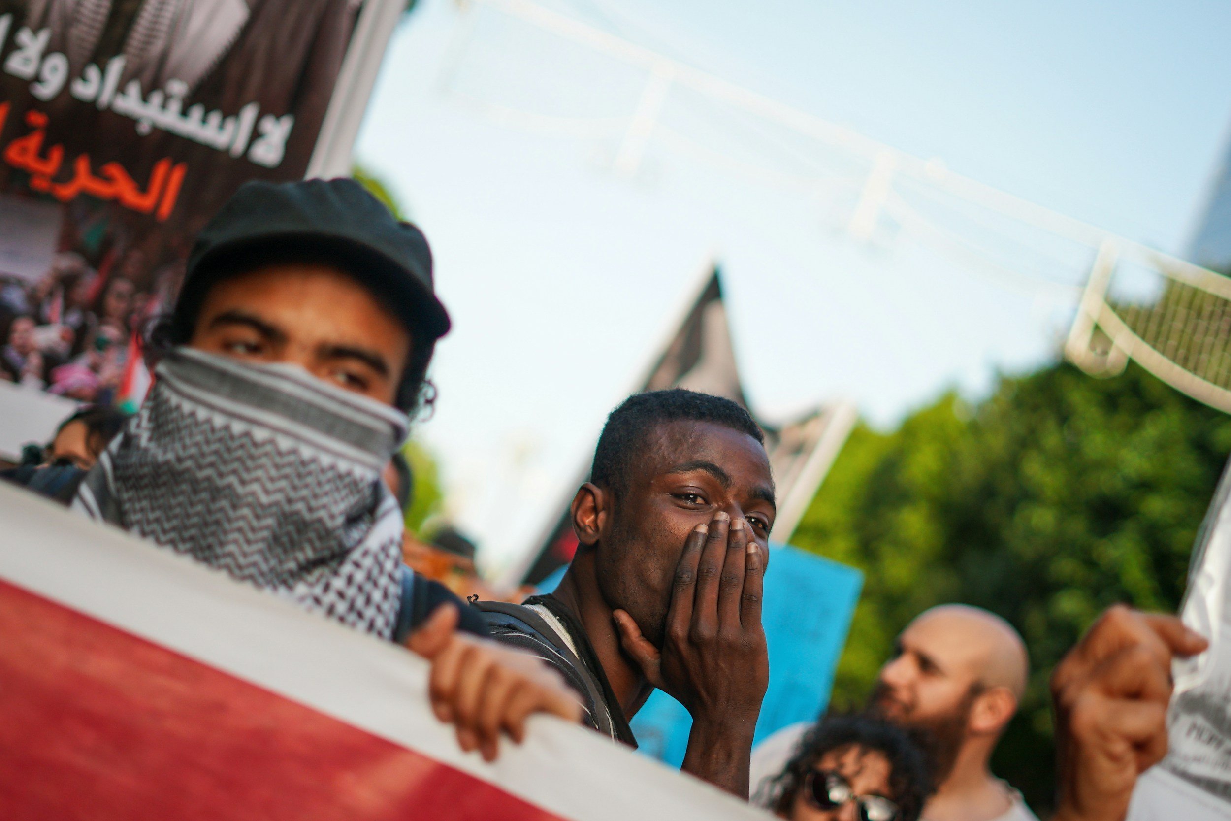 People at a protest holding signs and banners, showing how high-control dynamics can appear inside activist and social justice movements.
