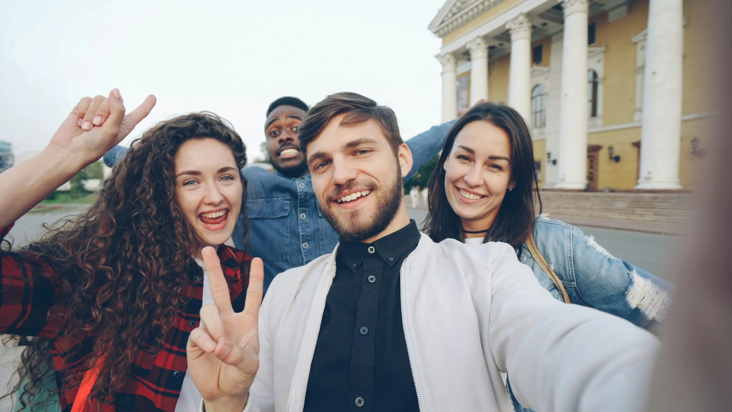 Group of four smiling adults representing polyamorous relationships in affirming therapy, Los Angeles