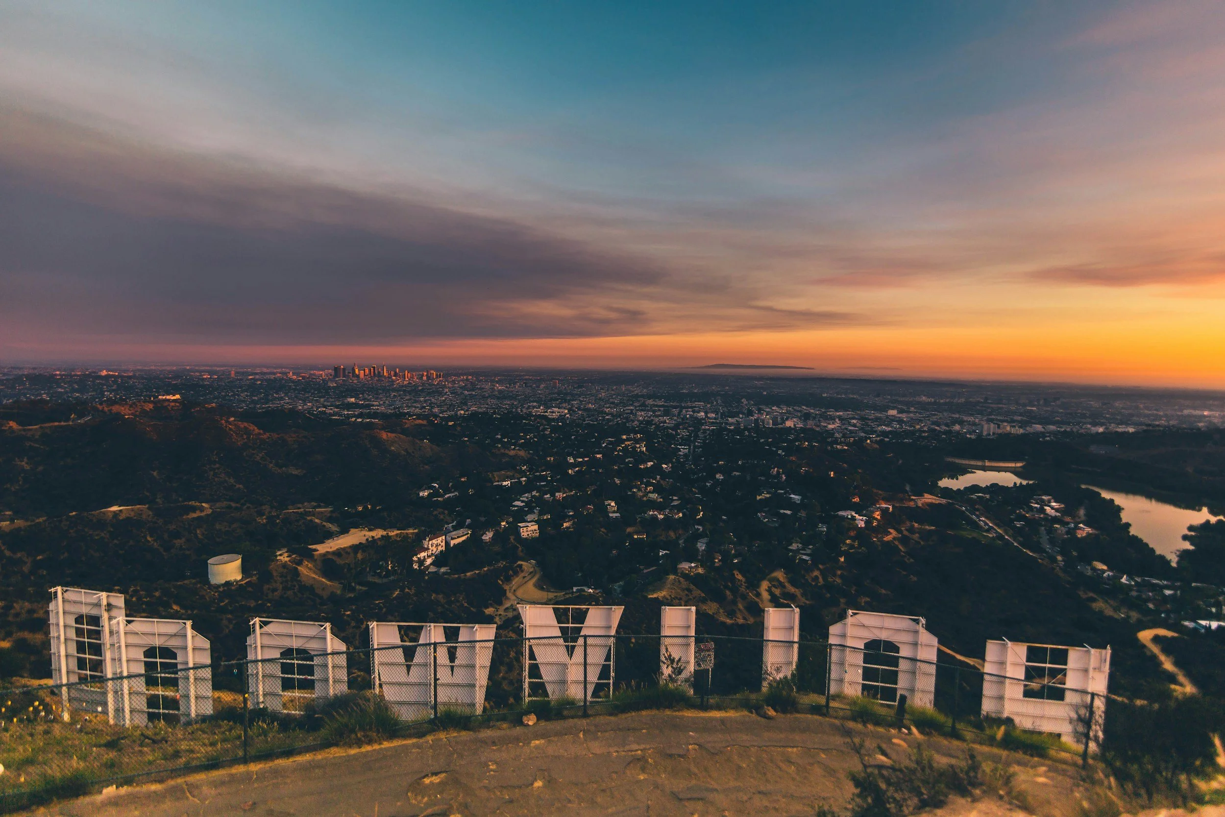 Hollywood Sign at sunset overlooking downtown Los Angeles skyline and hills