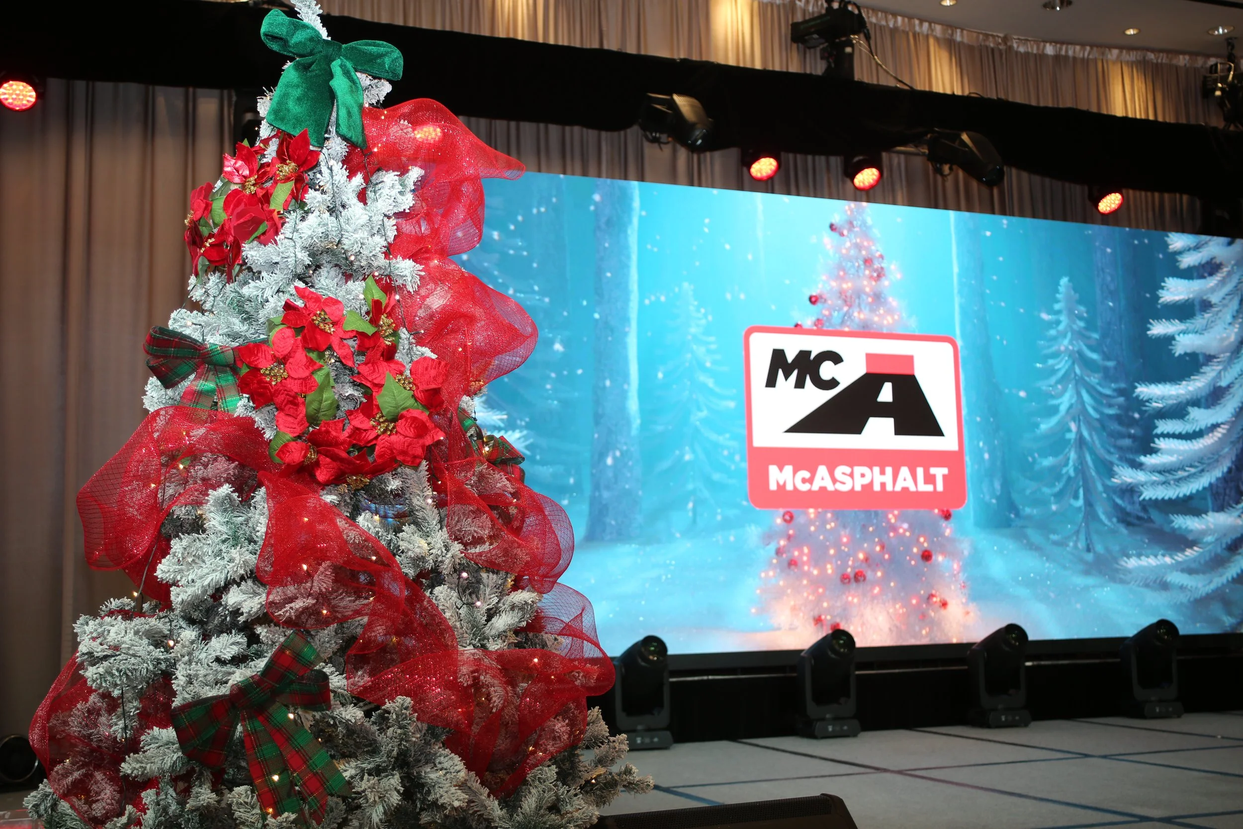 A decorated Christmas tree  winter scene backdrop for McASPHALT Holiday Event Designed by Alexandria Design House