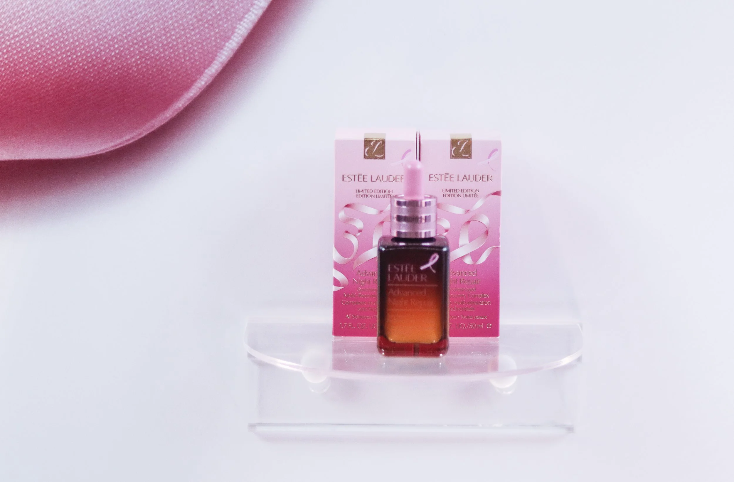 Estée Lauder advanced night repair serum with pink packaging and a pink ribbon design, Brand Activation Designed by Spatial  Event Architects Alexandria Design House 