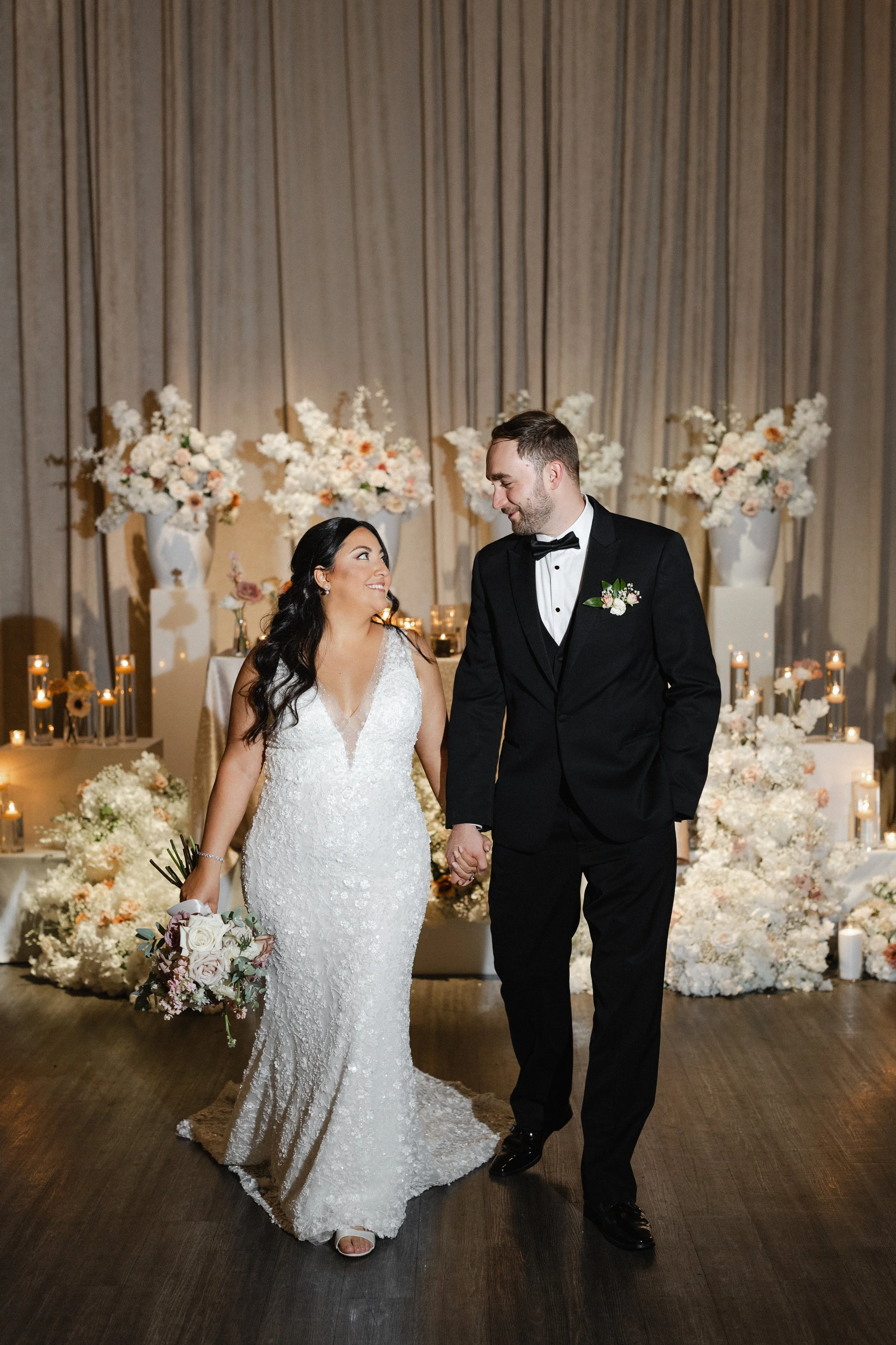 Bride and Groom in front of floral Decor