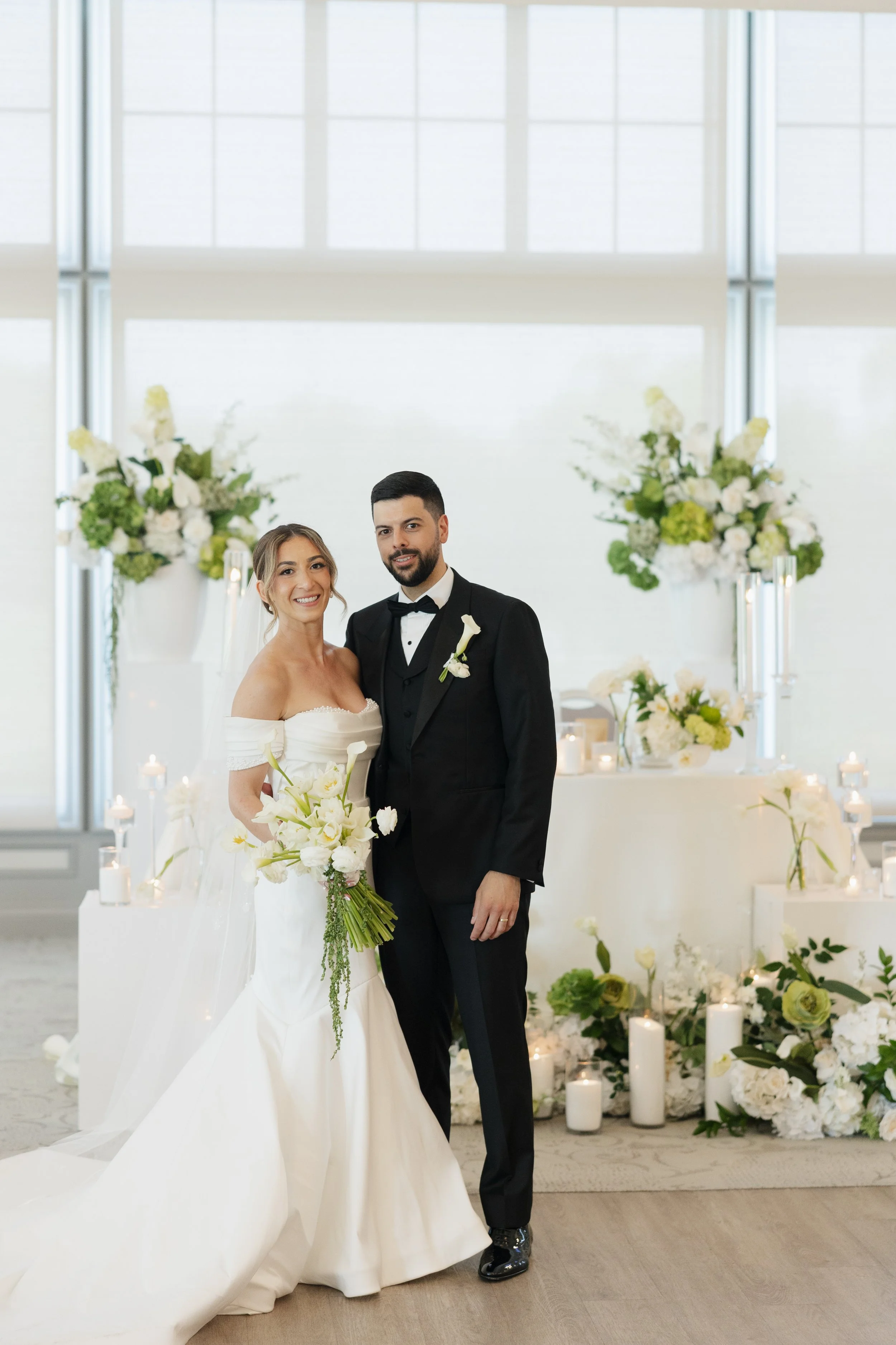 Bride in Groom in front of floral decor