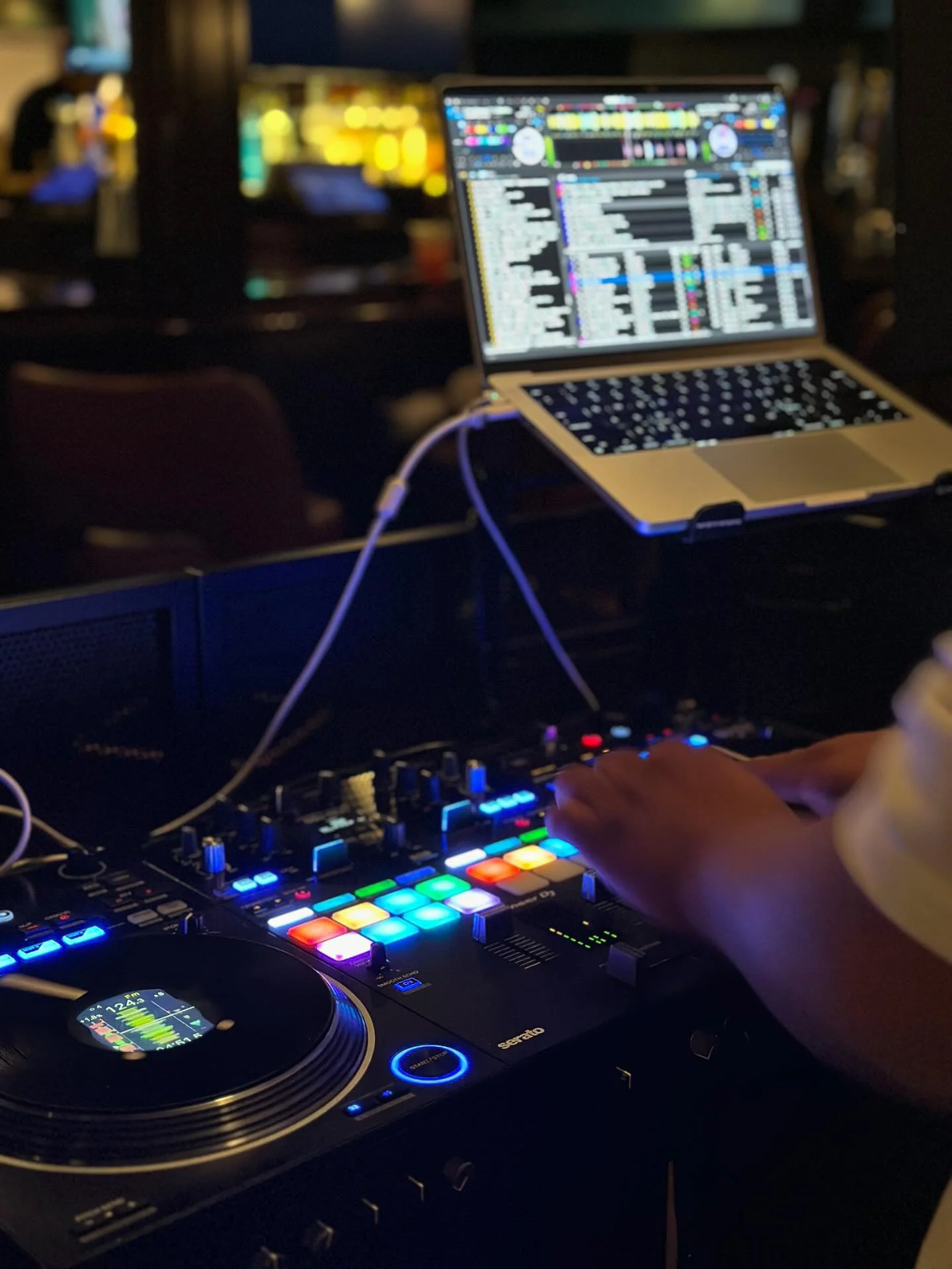 chequit dj decks rev 7 with bokeh background behind view.jpeg