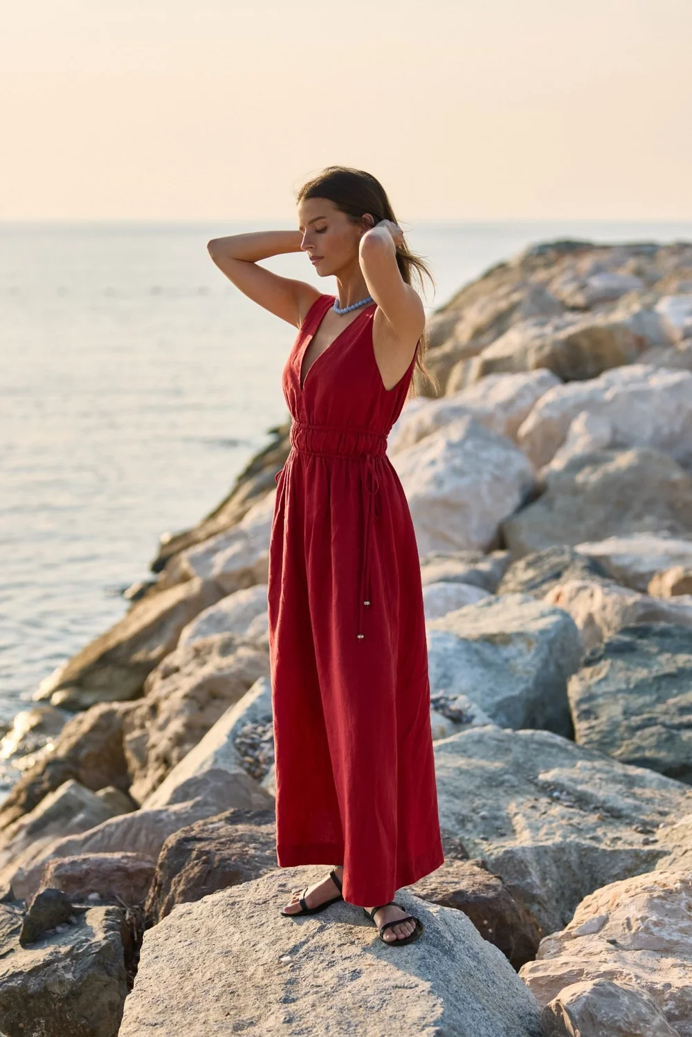 JAG campaign: red maxi dress on coastal rocks