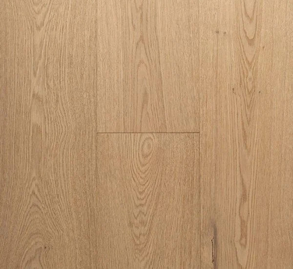 Close-up view of a wooden surface, likely hardwood flooring with visible wood grain and natural light color.