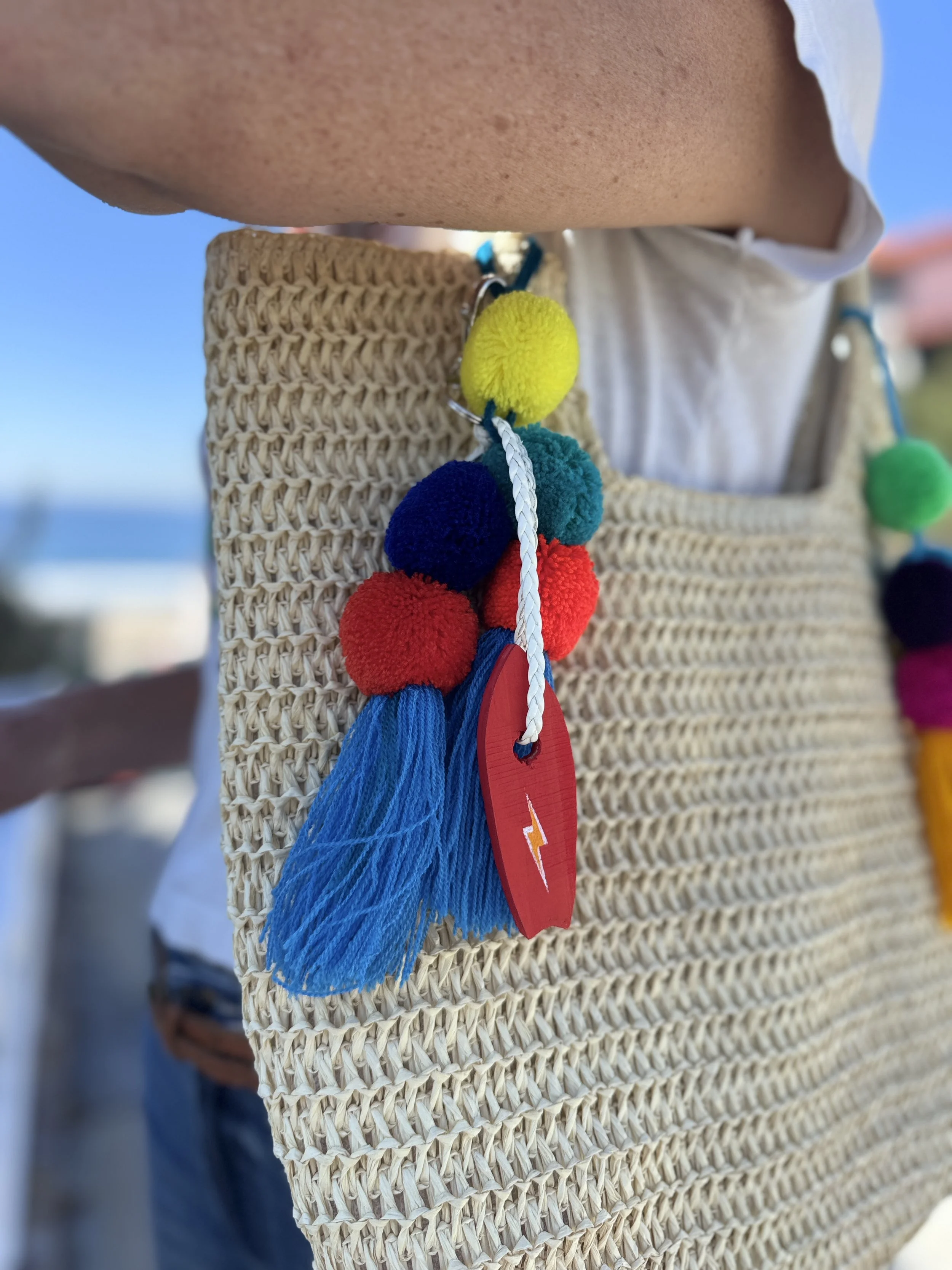 artist wears bag charm