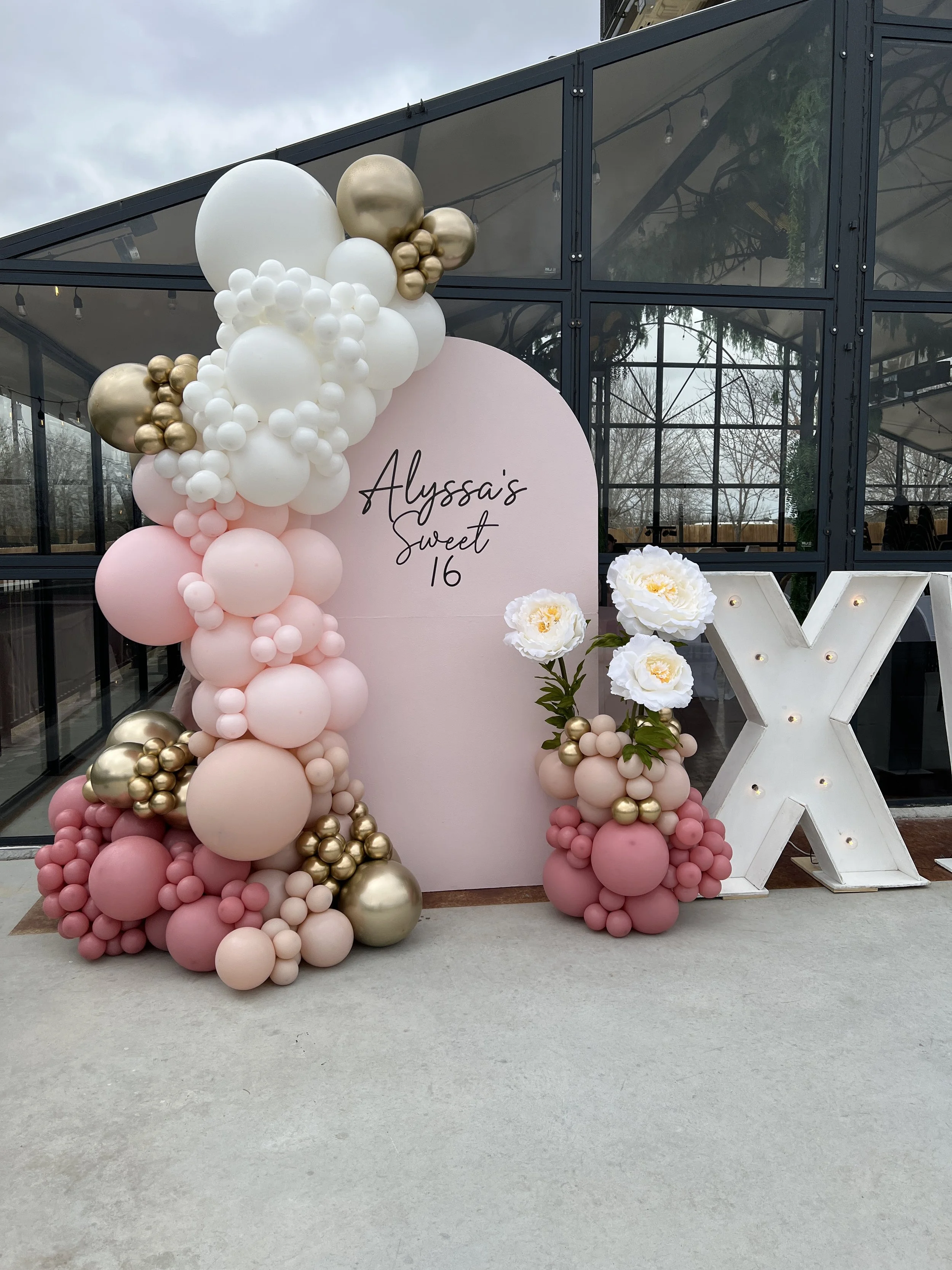 Sweet 16 backdrop and balloons