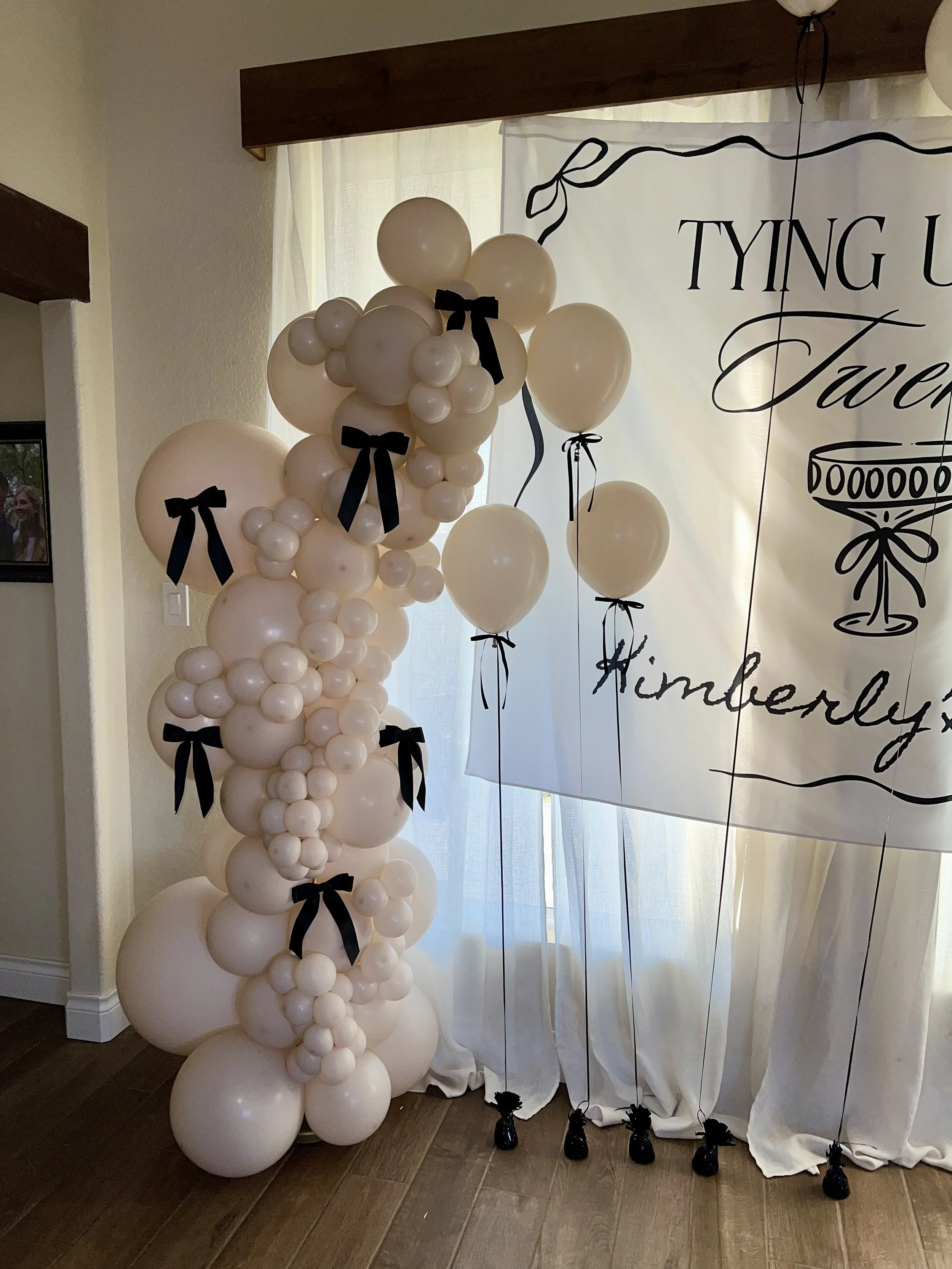Free standing balloon garland with bows and helium balloons