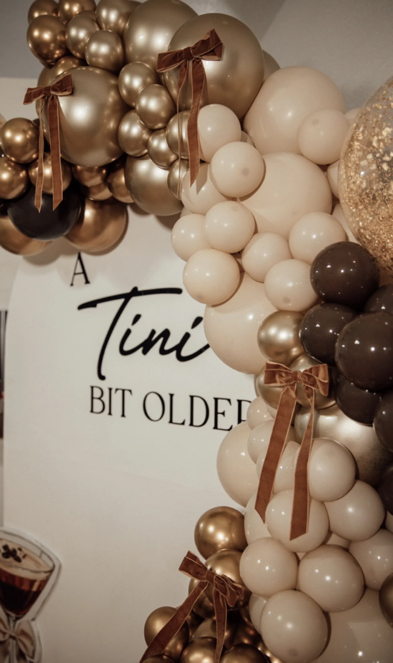 A Tini BIT OLDER balloon arch backdrop 