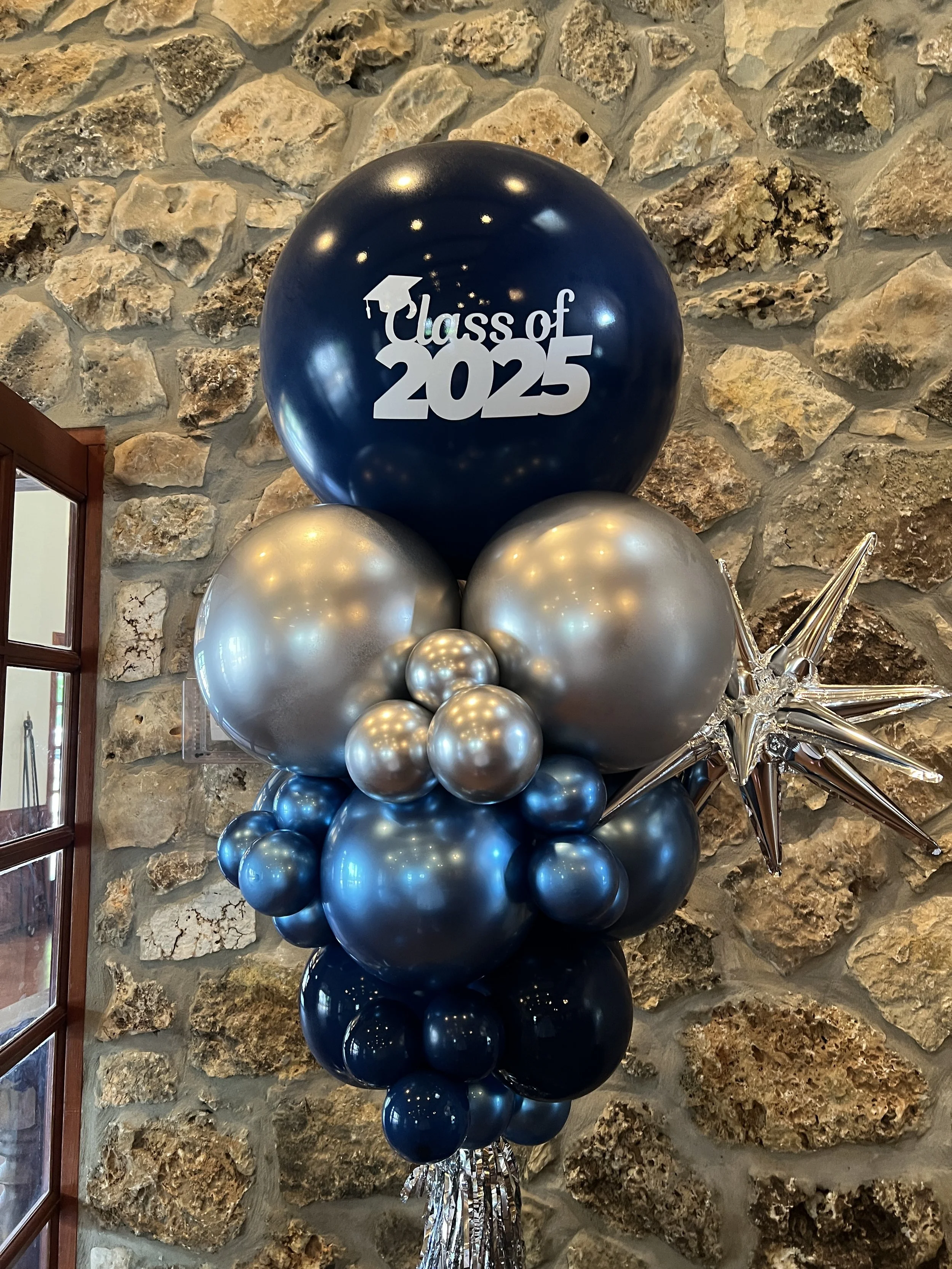 Custom balloon towers with themed toppers and tassels to match your event. 