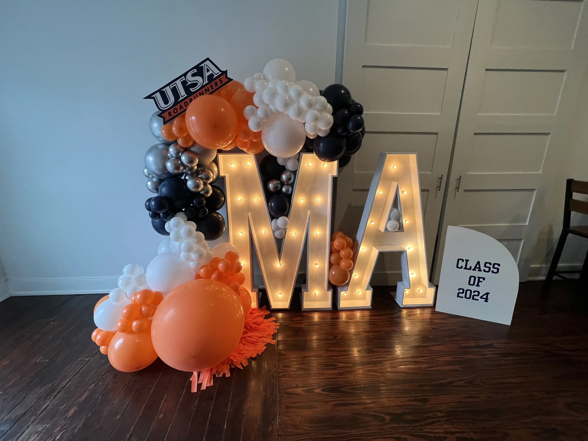 UTSA Graduation decorations, Marquee light rentals with balloons sign.