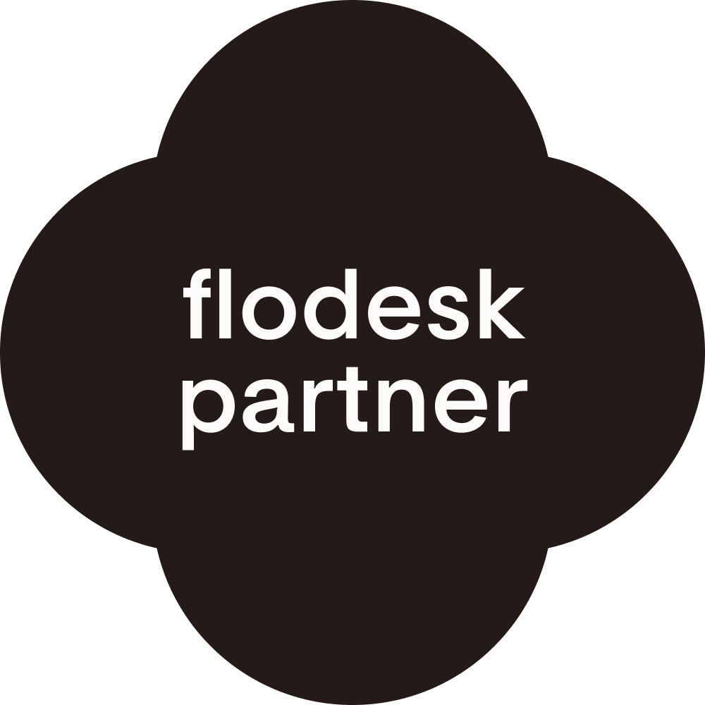 Black circular sharing button with white text that says 'flodesk partner'.