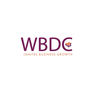 Logo for WBDC with the slogan 'Ignites Business Growth' in purple and orange colors.