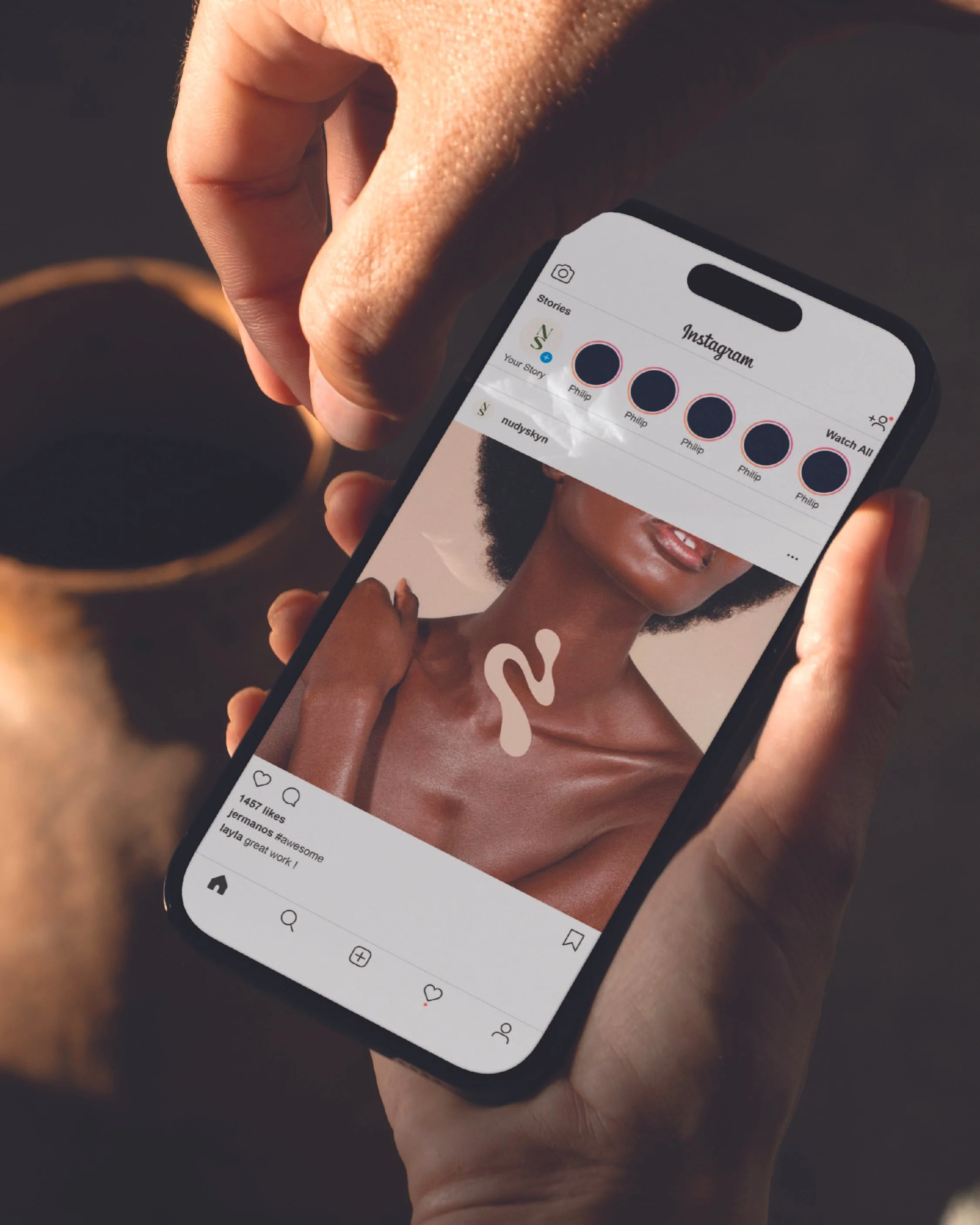 A person holding a smartphone displaying an Instagram photo of a woman with natural hair and bare shoulders, with Instagram stories visible at the top of the screen.