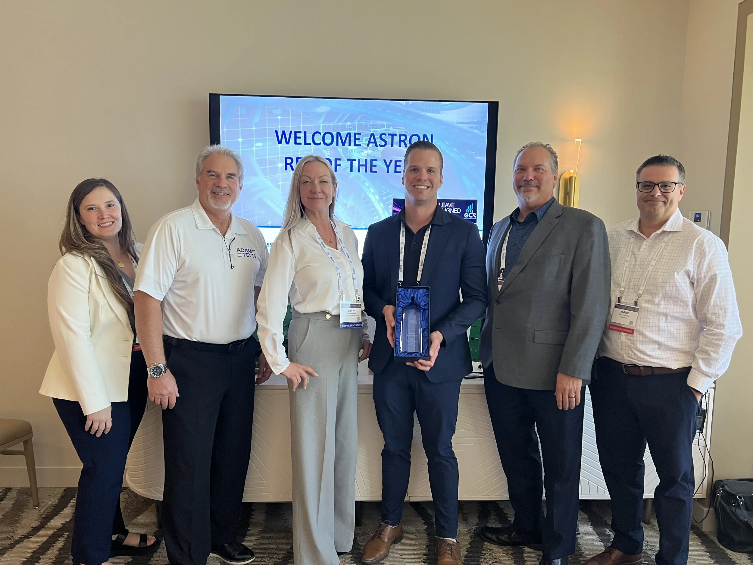 Picture of Astron Electronics receiving the Rep of the Year award from Adam-Tech.