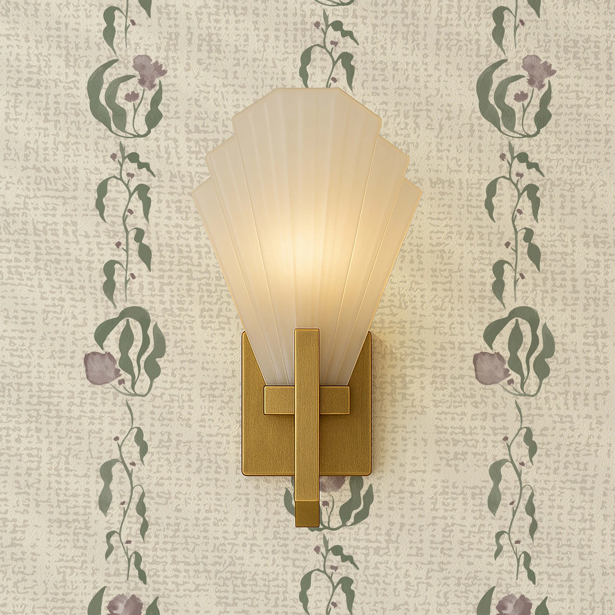 A wall-mounted decorative light fixture with a beige, scalloped shade and gold accents, set against a wallpapered wall with a textured pattern and green floral vines.